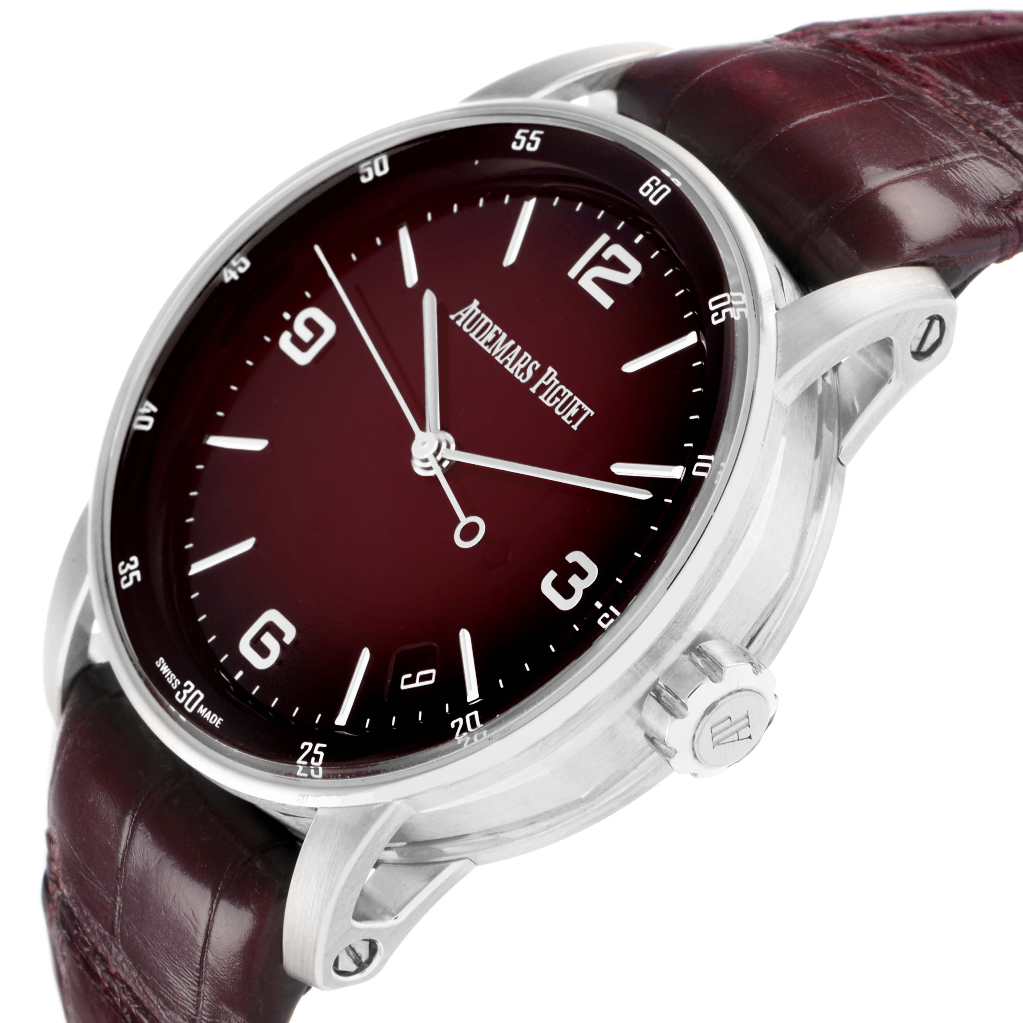 The Audemars Piguet Jules model 15210BC watch is shown at a diagonal angle, highlighting the burgundy dial, case, crown, and leather strap.