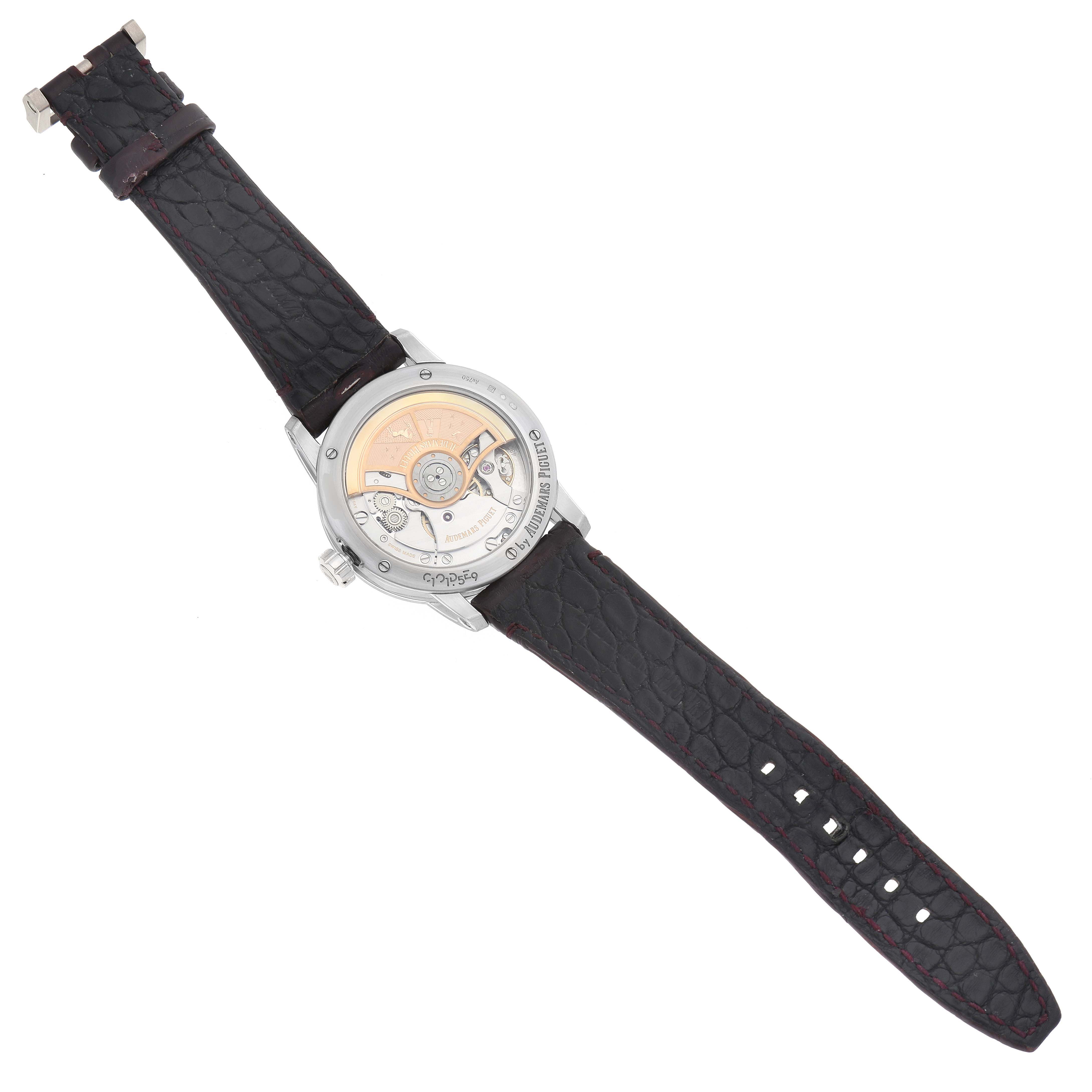 The Audemars Piguet Jules model 15210BC is shown from the back, revealing its movement and intricate mechanism, with a black leather strap visible.