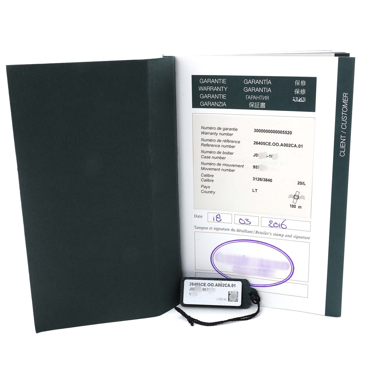 The image shows the warranty booklet and tag for the Audemars Piguet Royal Oak Offshore 26405CE.OO.A002CA.01 Men's Ceramic Grey Dial model.