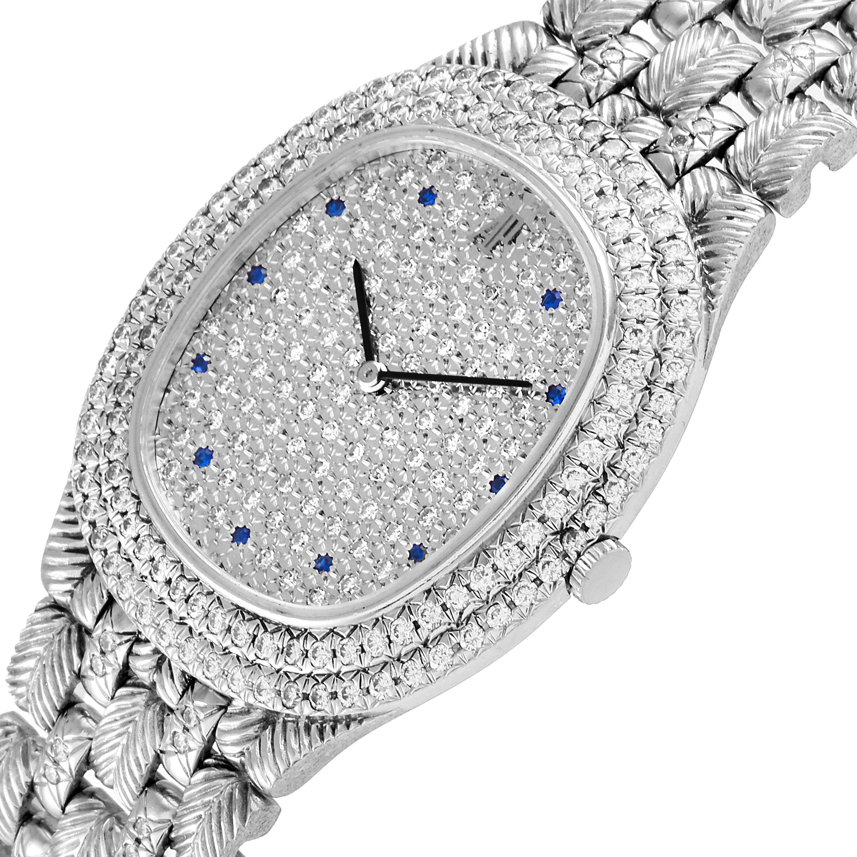 The Vintage model by Audemars Piguet is shown at an angled top-down view, highlighting the diamond-encrusted face and intricate metal bracelet.