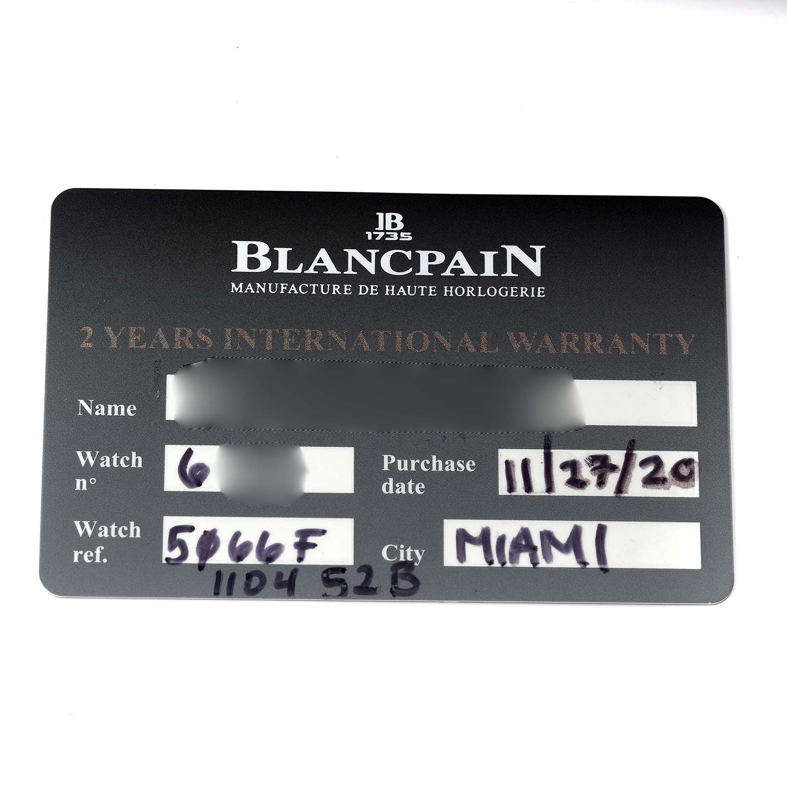 The image shows an international warranty card for the Blancpain Fifty Fathoms watch, model number 5066F-1140-52B, with purchase details.