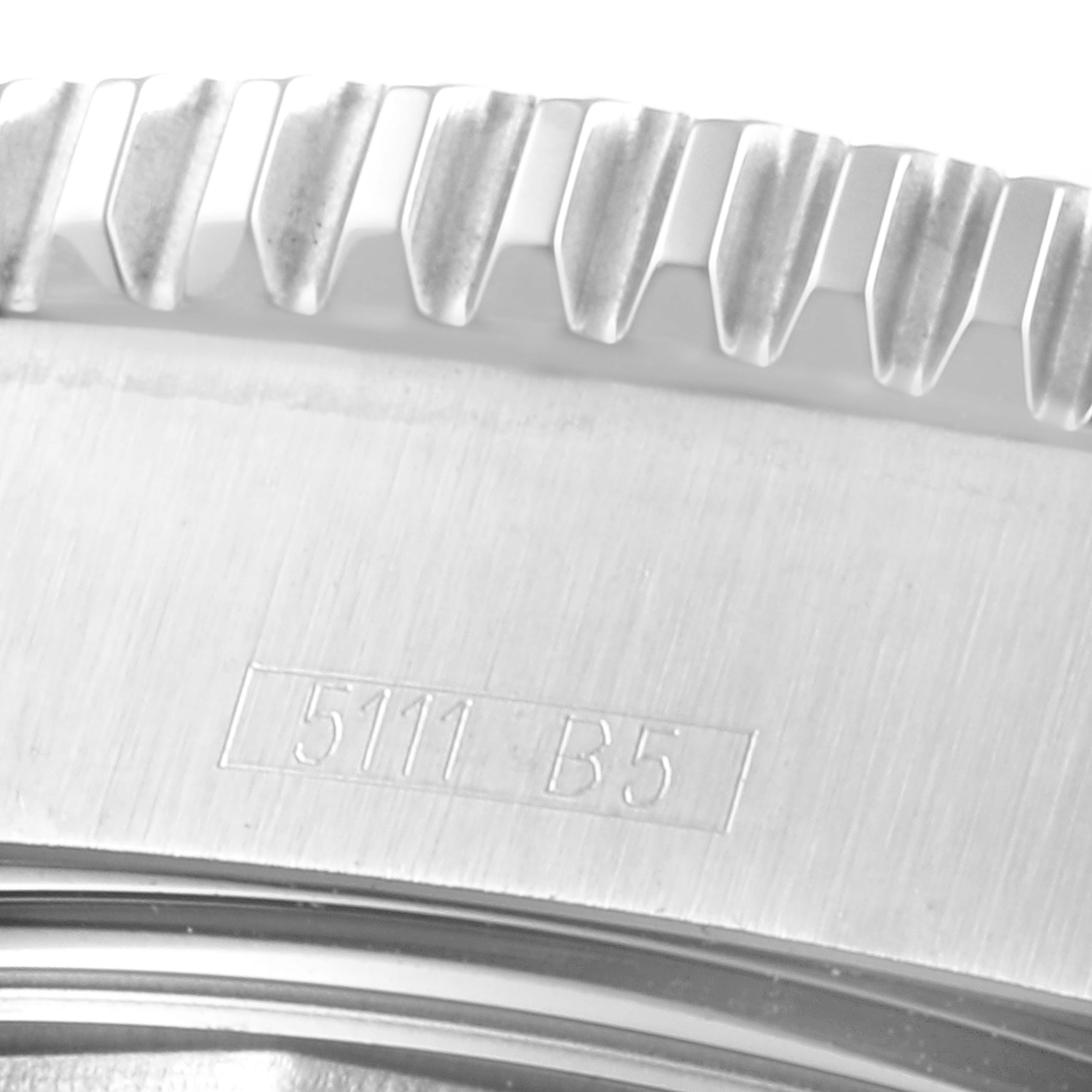 This close-up image shows the edge of the bezel and case of a Breitling Superocean A17391 Men
s Stainless Steel Black Dial A17391 Men
s Stainless Steel Black Dial watch, with visible serial numbers.