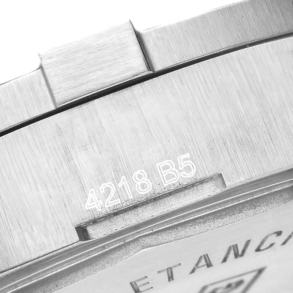 The image shows a close-up of the case back edge and part of the bezel of the Breitling Colt A17313 men's watch, revealing engraved markings.
