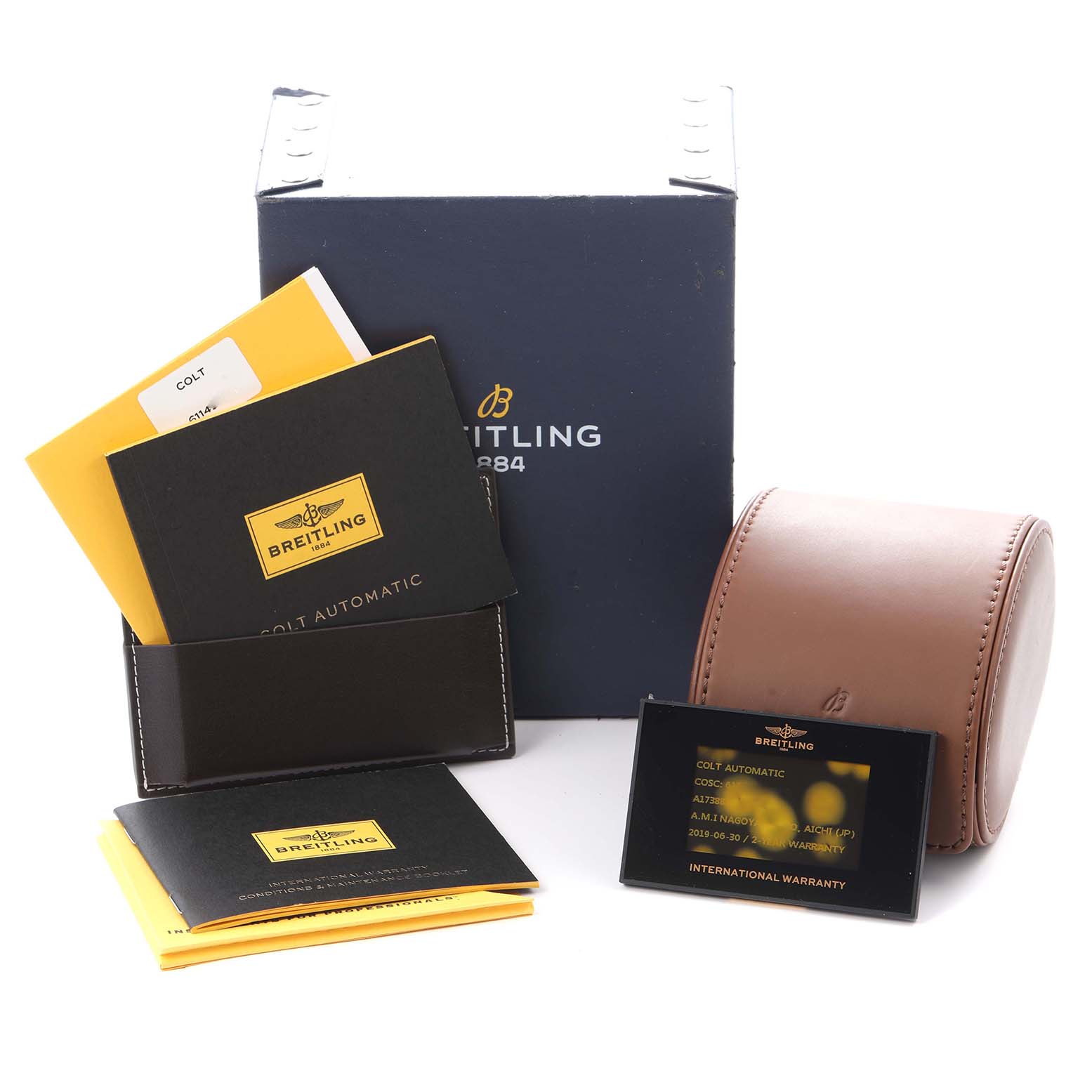 The image shows the packaging and accessories for the Breitling Colt A17388 Men's watch, including a box, manuals, a leather case, and a warranty card.