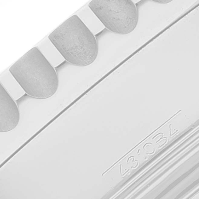 Close-up of the bezel and part of the case back of a Breitling Navitimer AB0121 Men's Stainless Steel Black Dial AB0121 Men's Stainless Steel Black Dial watch, showcasing its textured edge and engraving.