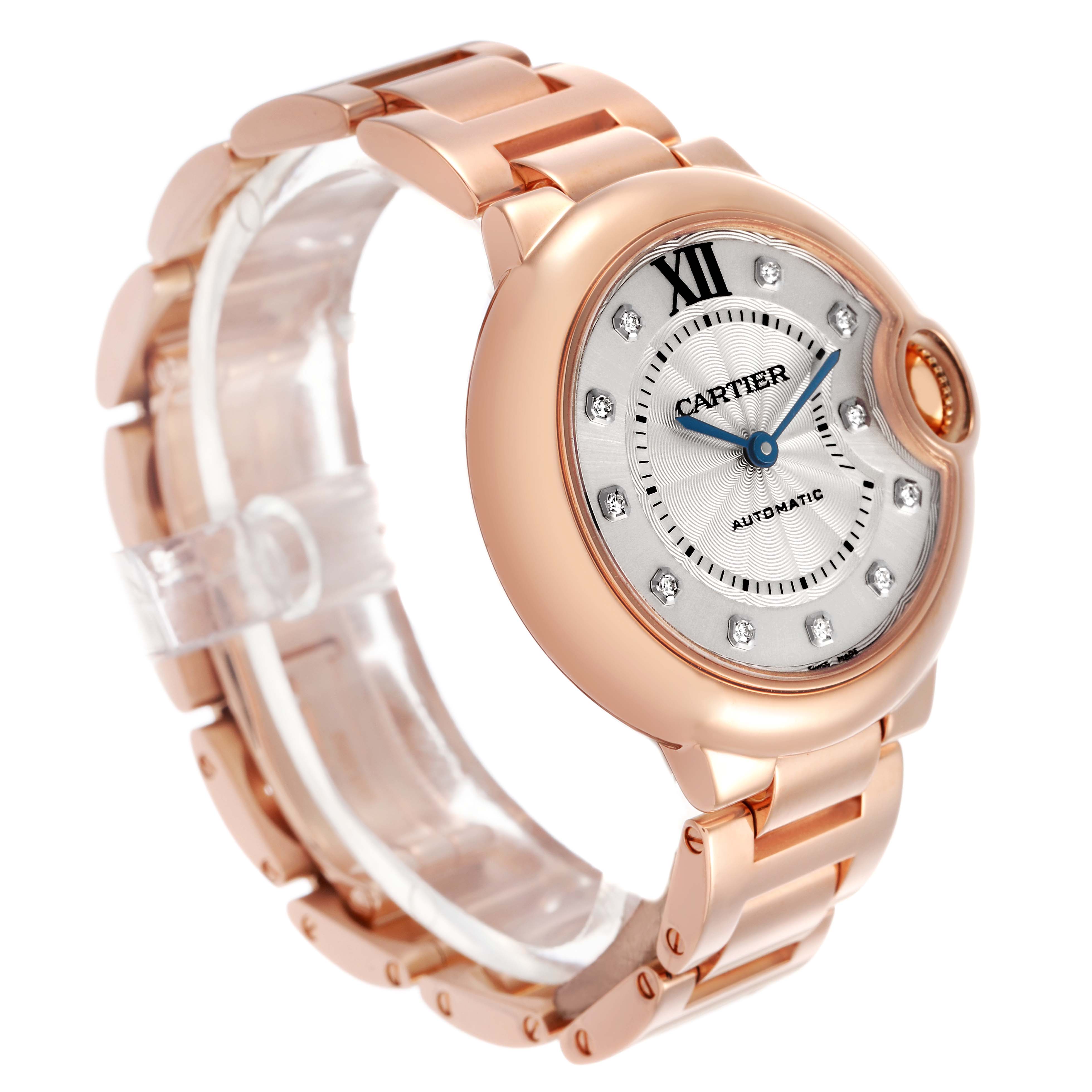The Cartier Ballon Bleu WE902034 Women's Rose Gold Silver Dial watch is shown at a three-quarter angle highlighting the rose gold casing, bracelet, and diamond markers.