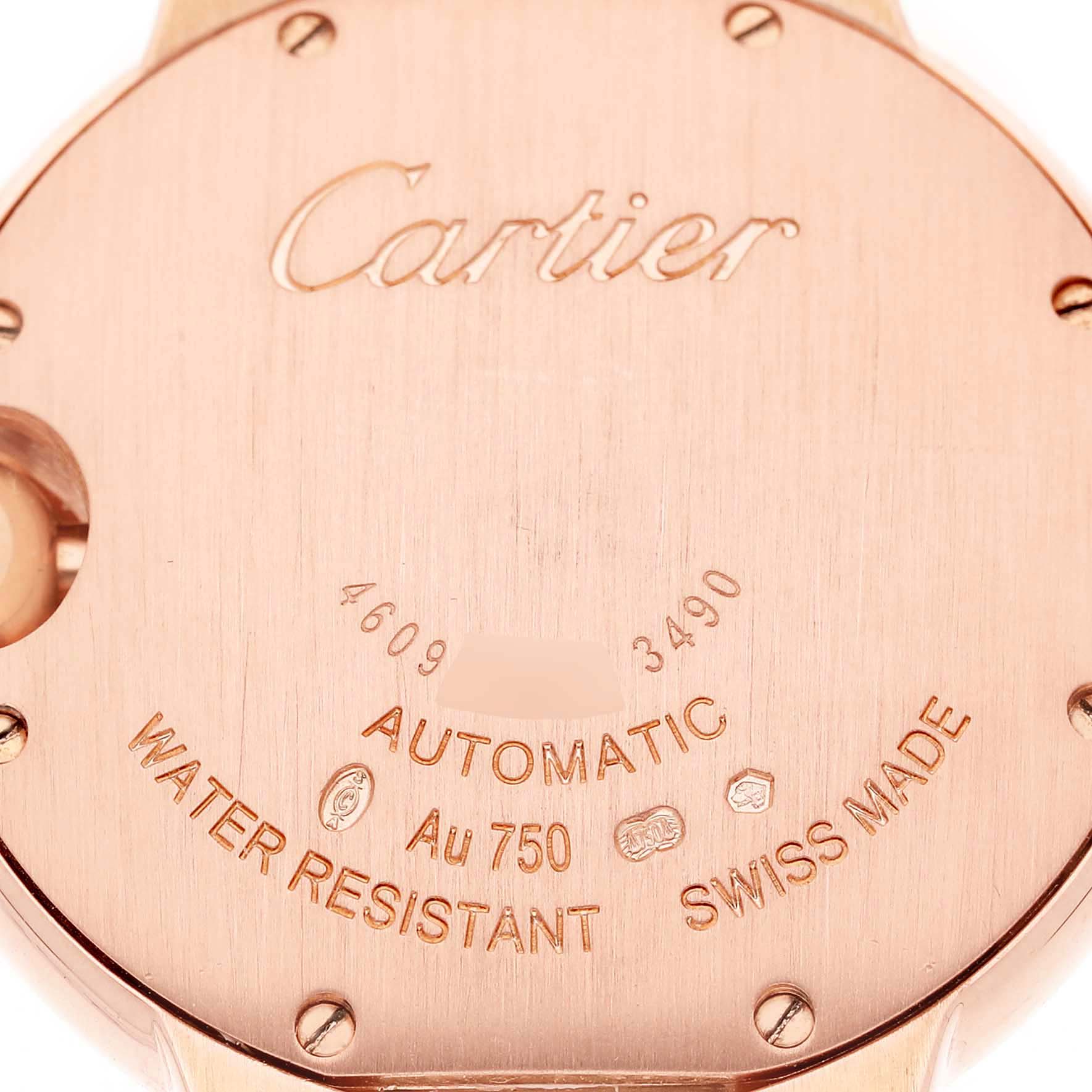 The image shows the case back of a Cartier Ballon Bleu WE902034 Women's Rose Gold Silver Dial watch, highlighting engravings and hallmarks.