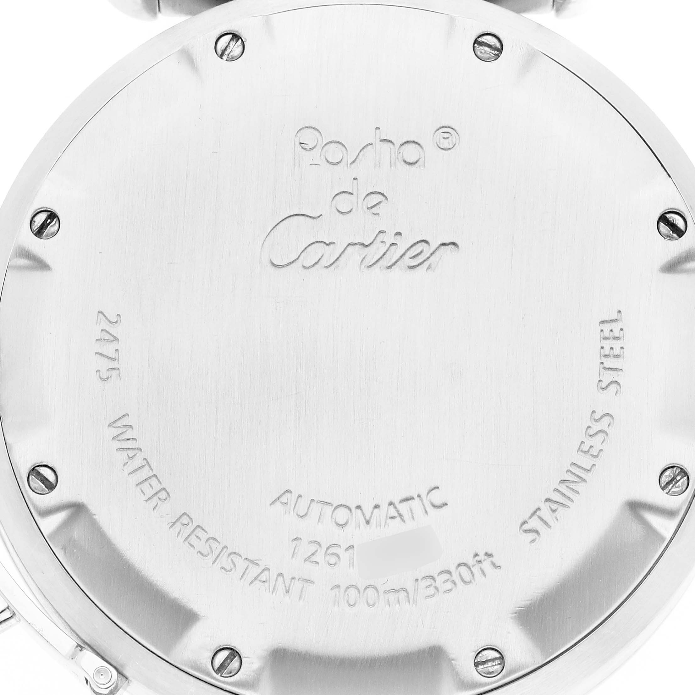 The image shows the back of a Cartier Pasha model W31058M7 men's watch, featuring engravings and screws.