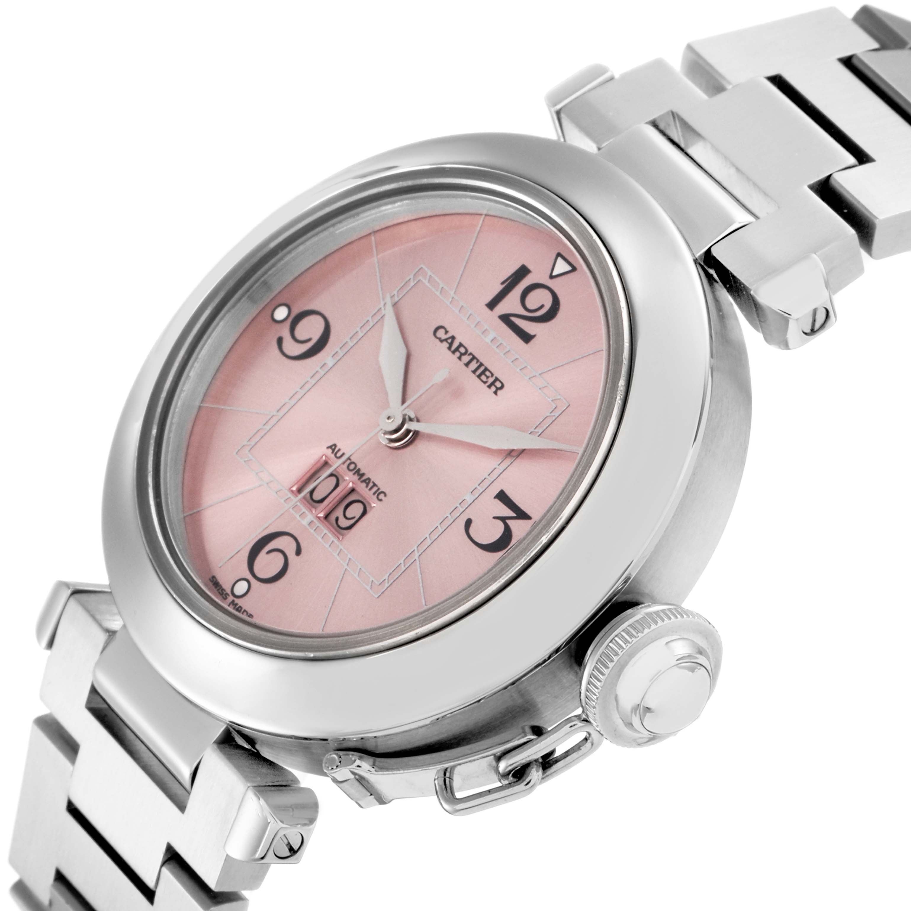 The image shows a Cartier Pasha model W31058M7 men's watch at an angle highlighting its pink dial, crown, and part of the metal bracelet.