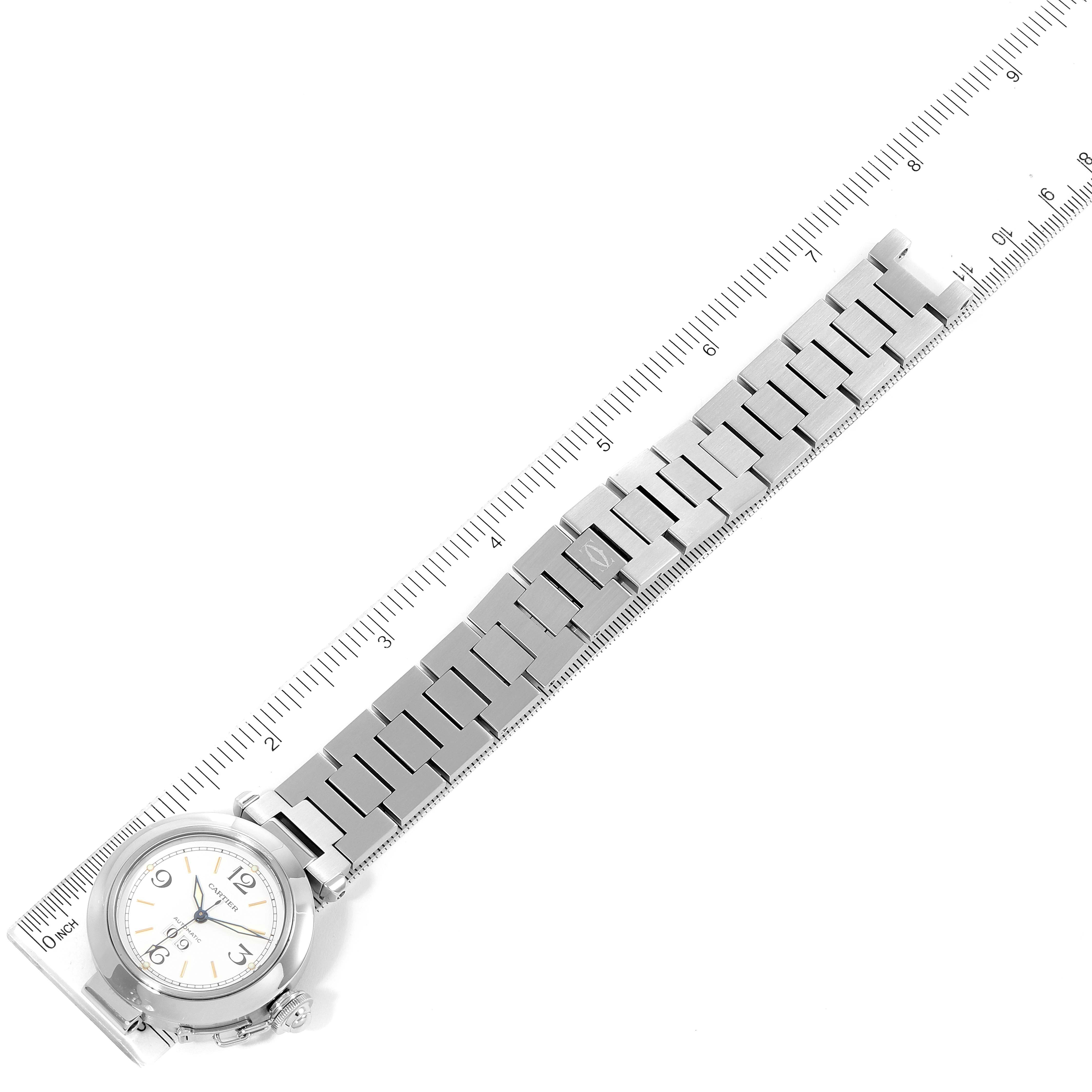 This image shows a top-down view of the Cartier Pasha W31044M7 Women's Stainless Steel White Dial W31044M7 Women's Stainless Steel White Dial model watch with a stainless steel bracelet, placed next to a ruler for scale.