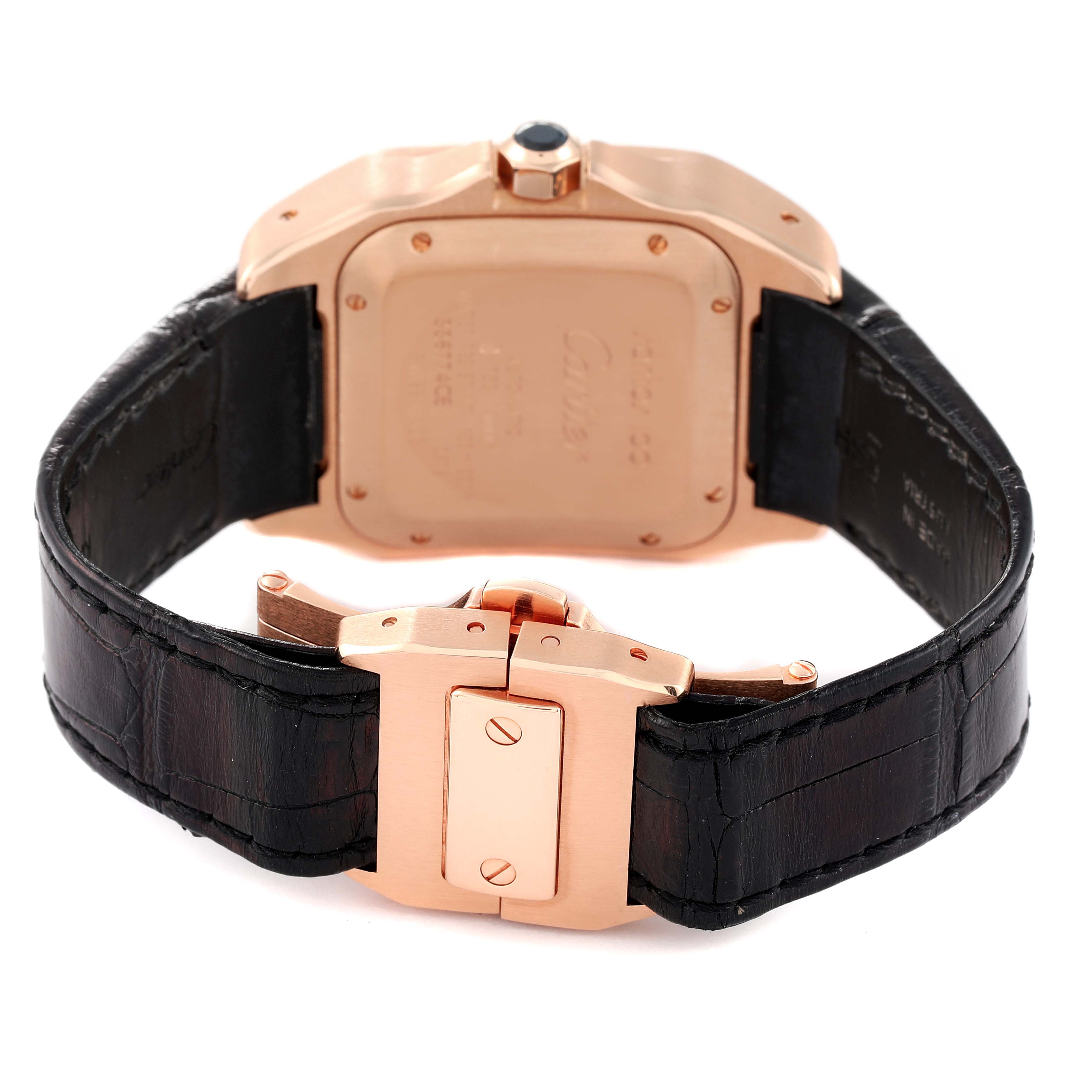 The image shows the backside and clasp of a Cartier Santos W20108Y1 Men's Rose Gold Silver Dial W20108Y1 Men's Rose Gold Silver Dial watch, highlighting its case back and leather strap.