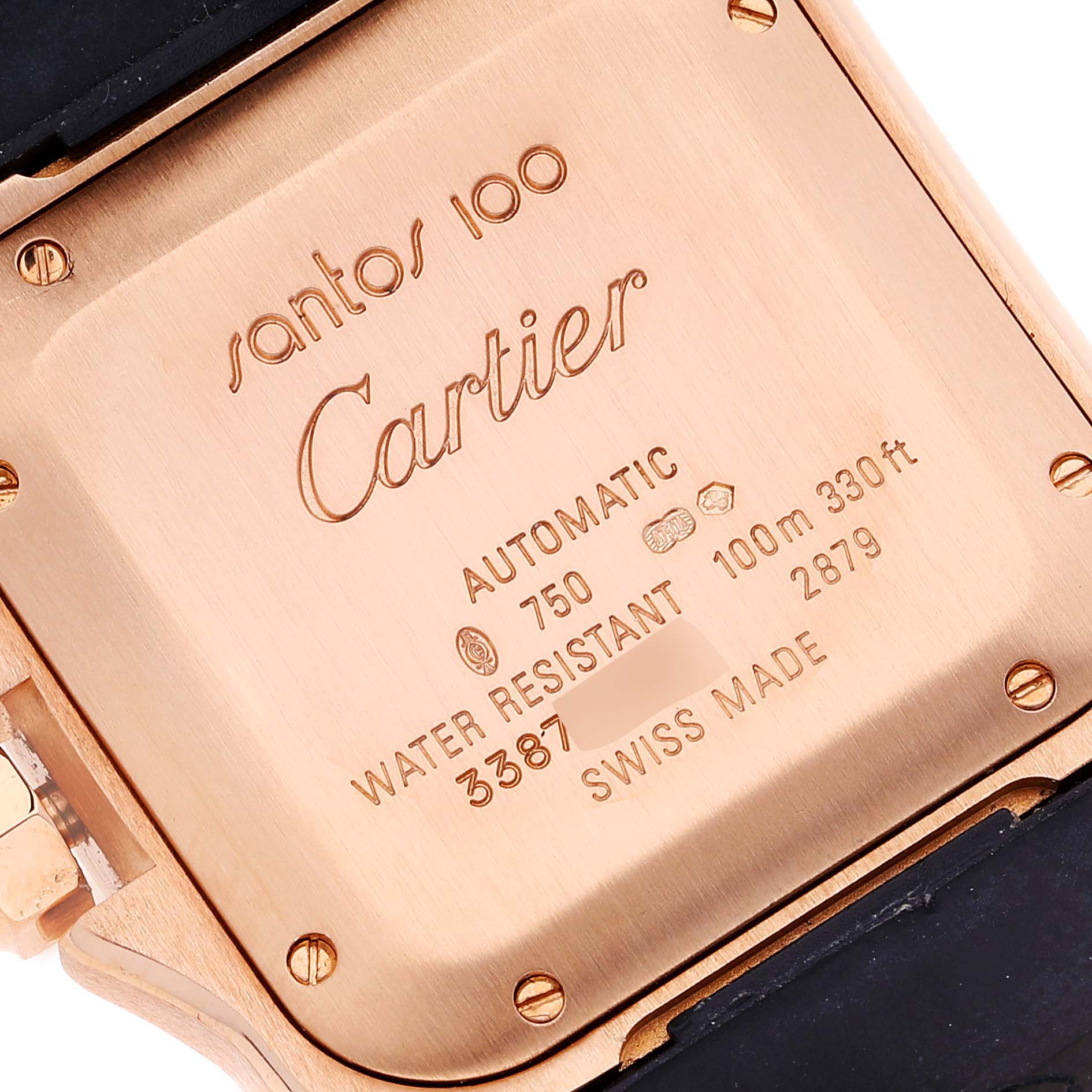 The image shows the case back of a Santos 100 by Cartier, highlighting engravings and markings.