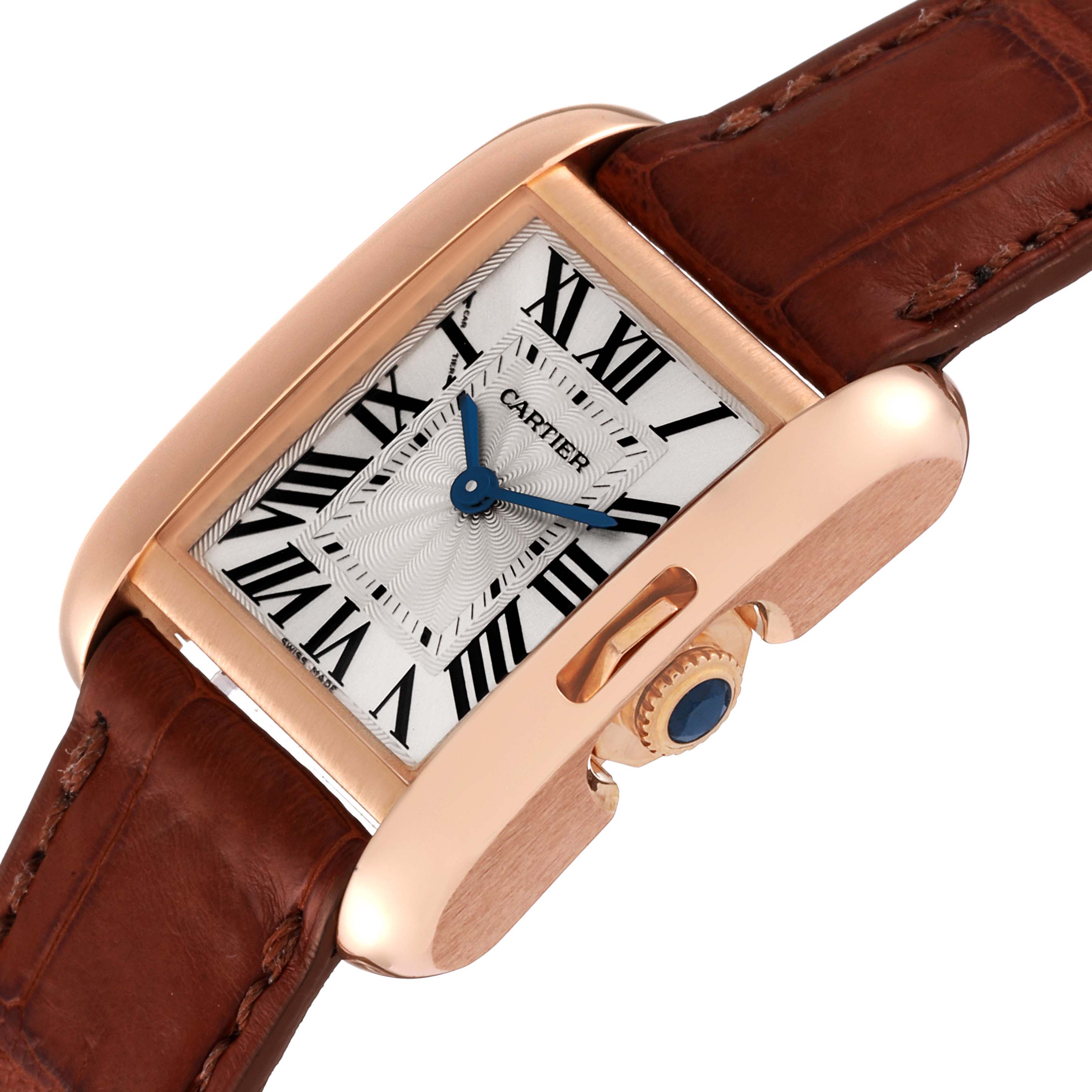 This Cartier Tank Anglaise W5310027 Women
s Rose Gold Silver Dial W5310027 Women
s Rose Gold Silver Dial watch is shown from a three-quarter angle, highlighting the crown, dial, and leather strap.