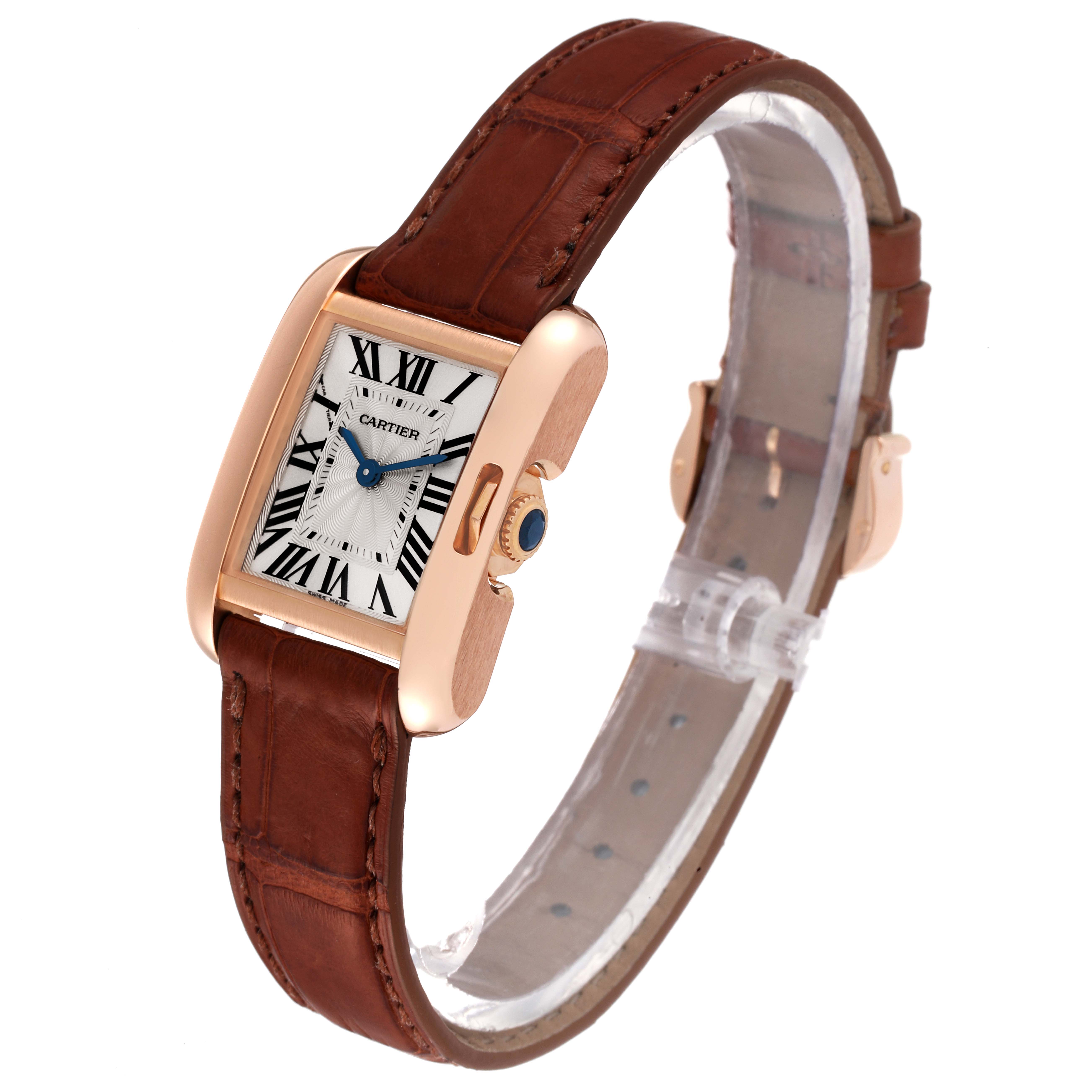 The Cartier Tank Anglaise W5310027 Women
s Rose Gold Silver Dial W5310027 Women
s Rose Gold Silver Dial watch is shown at a slight angle, displaying its brown leather strap, rectangular face, and crown.