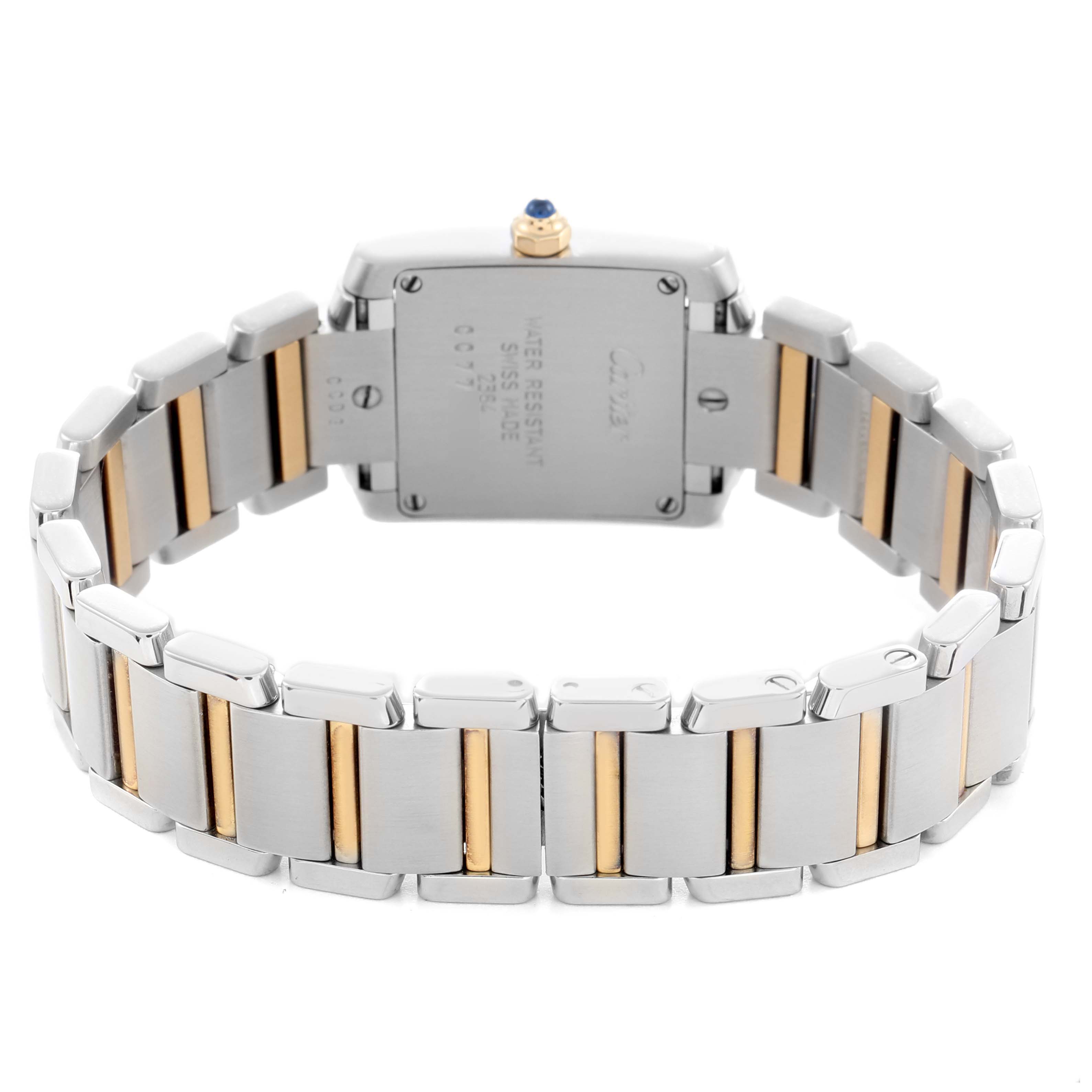 The image shows the back view of a Cartier Tank Francaise, model number W51007Q4, highlighting its metal bracelet with gold accents and case back.
