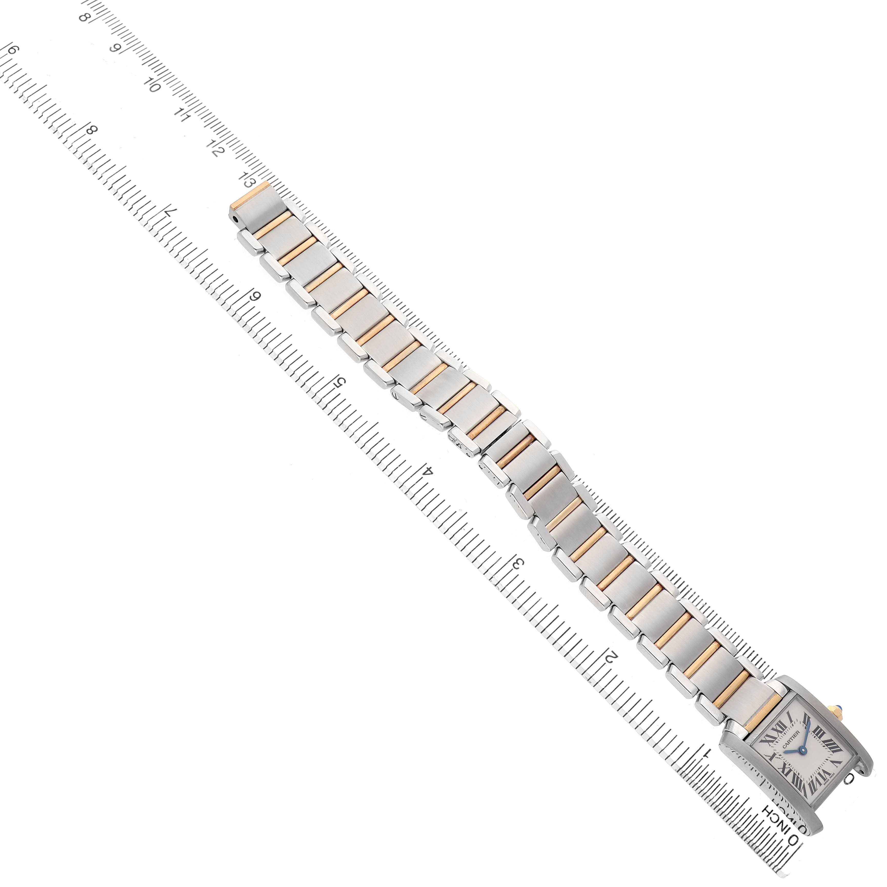 The Cartier Tank Francaise W51007Q4 Women's Stainless Steel Silver Dial watch is shown from the top view with the full bracelet and face visible, aligned next to a ruler.