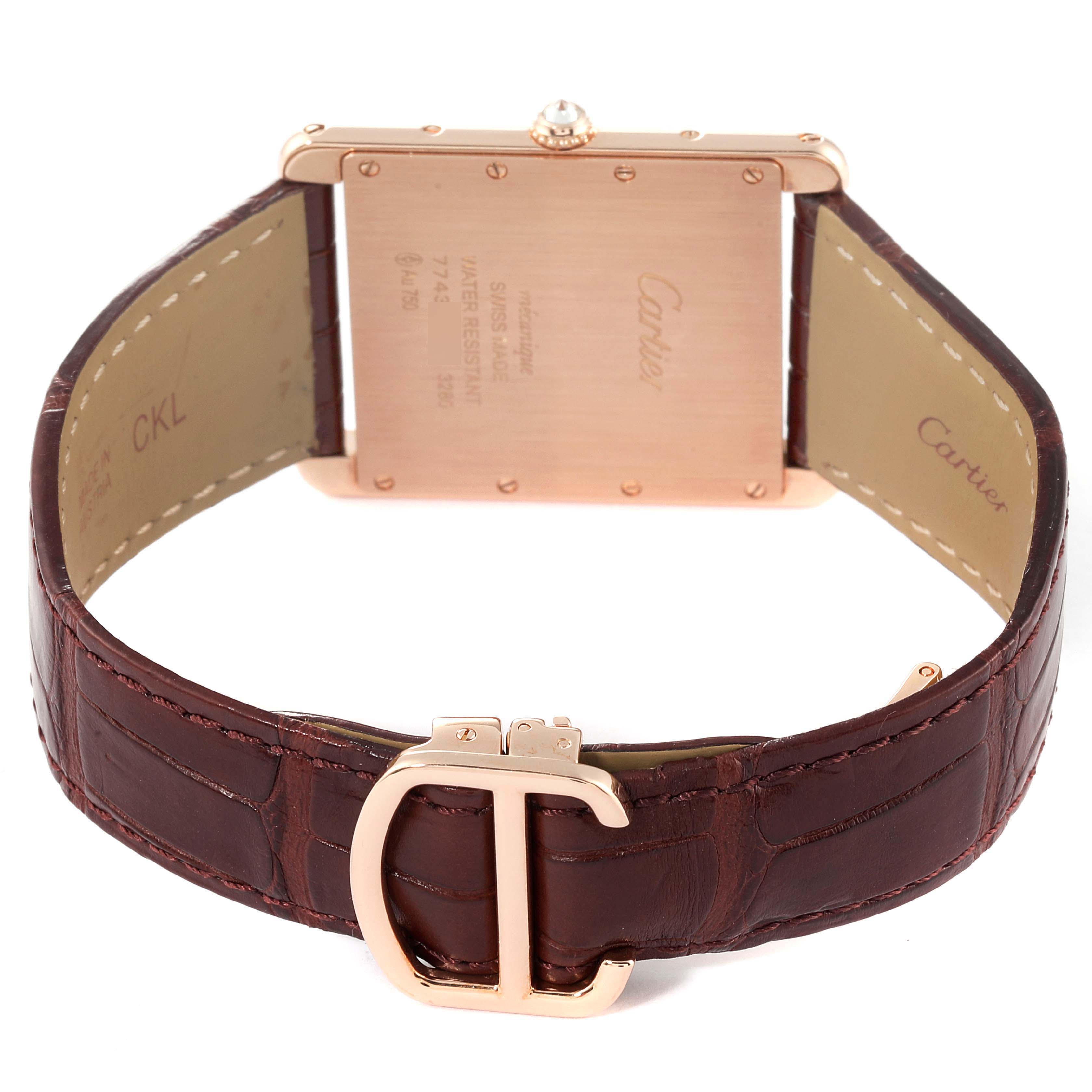 The Cartier Tank Louis WT200005 Men's Rose Gold Silver Dial WT200005 Men's Rose Gold Silver Dial watch is shown from the back, highlighting the case back and the leather strap with a "C" buckle.