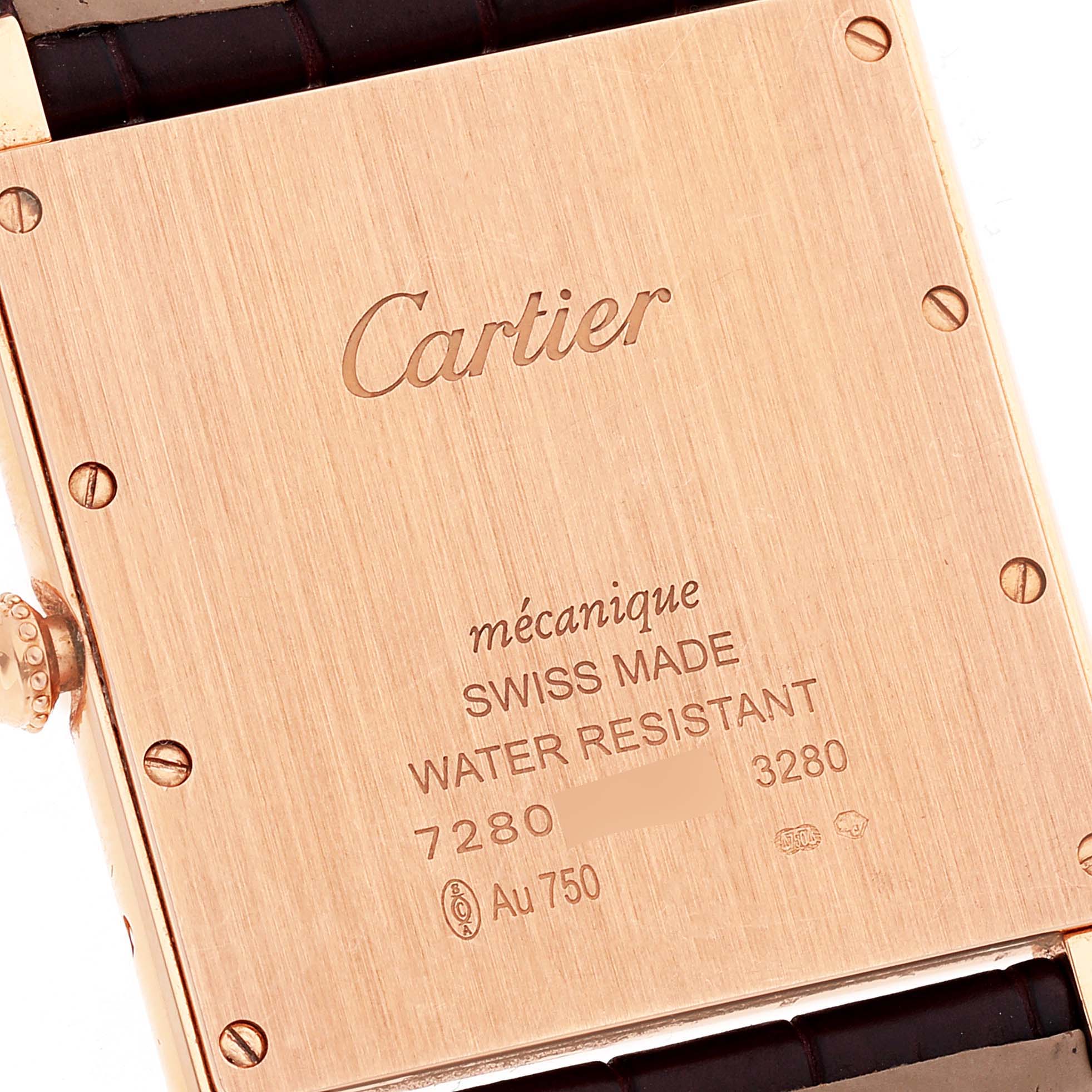 The image shows the back case of the Tank Louis Cartier watch, displaying engravings and part of the strap.