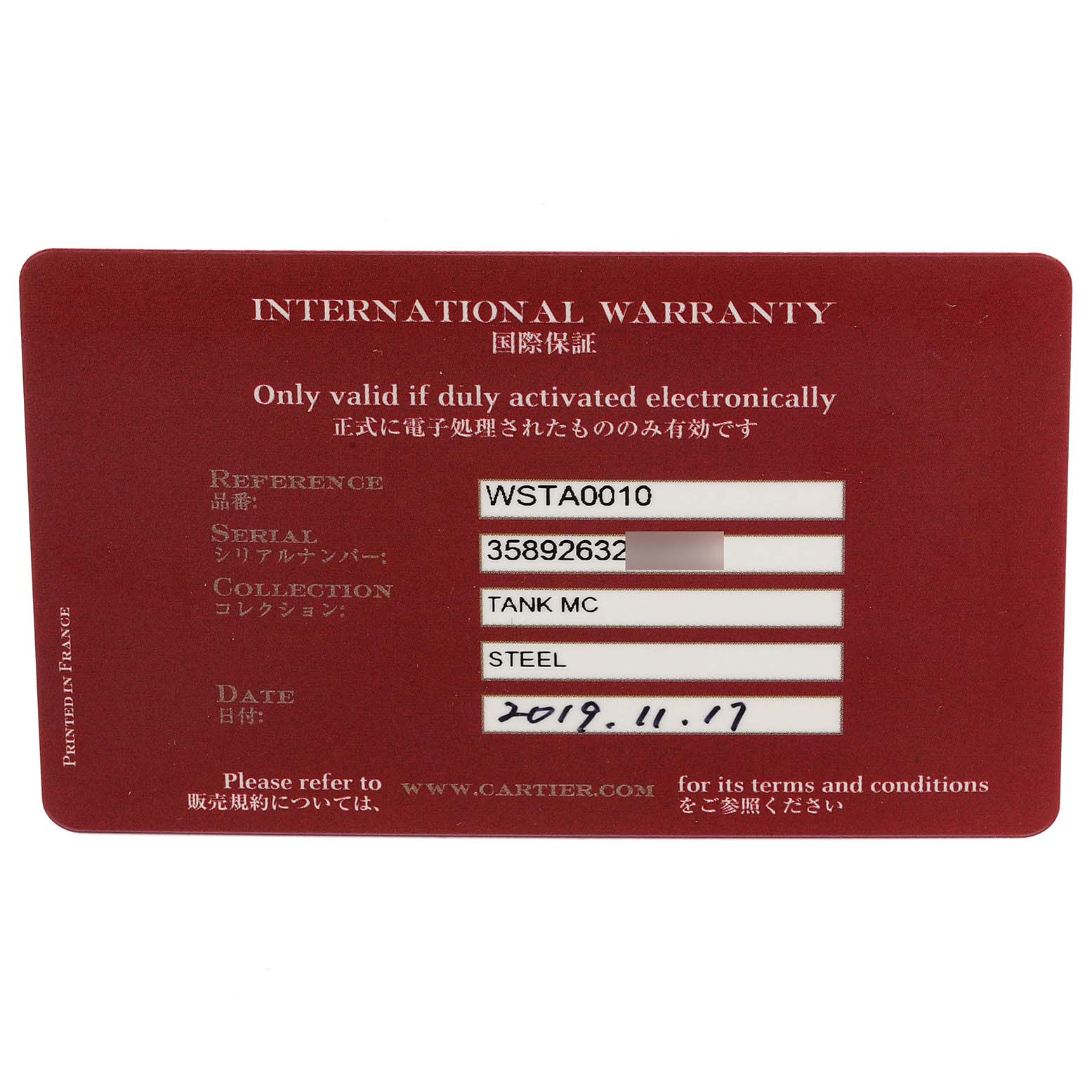 This image displays an international warranty card for the Cartier Tank MC WSTA0010 Men's Stainless Steel Blue Dial WSTA0010 Men's Stainless Steel Blue Dial model watch, viewed from a top-down angle.