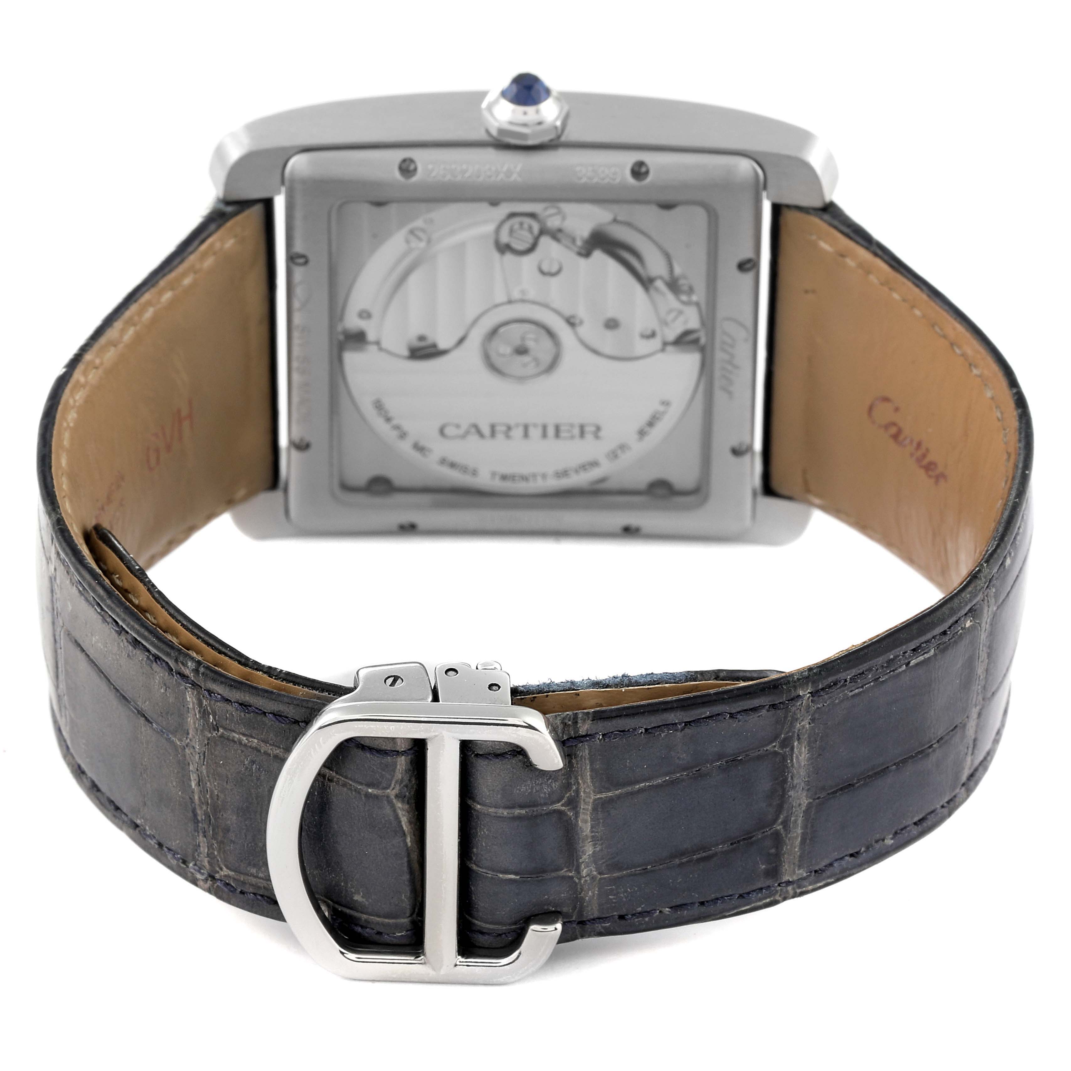 The image shows the back view of a Cartier Tank MC WSTA0010 Men's Stainless Steel Blue Dial WSTA0010 Men's Stainless Steel Blue Dial watch, highlighting the movement through the display case back and the leather strap with a clasp.