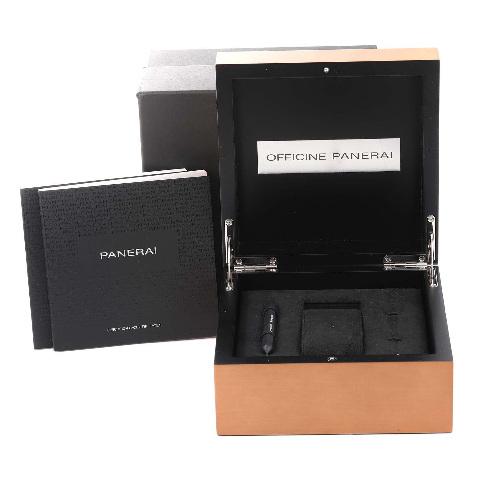 The image shows an open Luminor by Panerai watch box with a booklet and a tool beside it.
