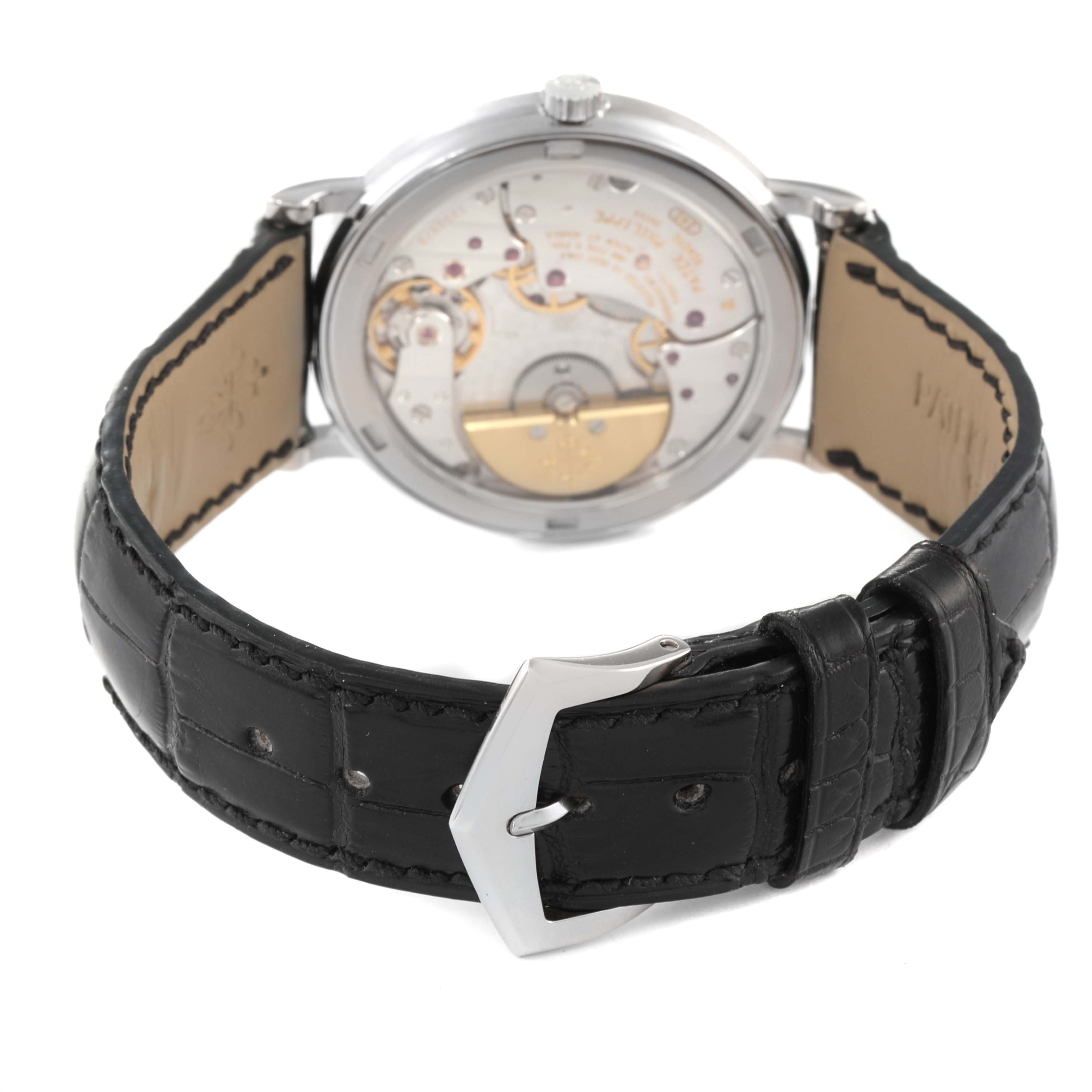 The image shows the back view and clasp of a Patek Philippe Calatrava 5120G Men's White Gold White Dial 5120G Men's White Gold White Dial watch, highlighting its movement and leather strap.