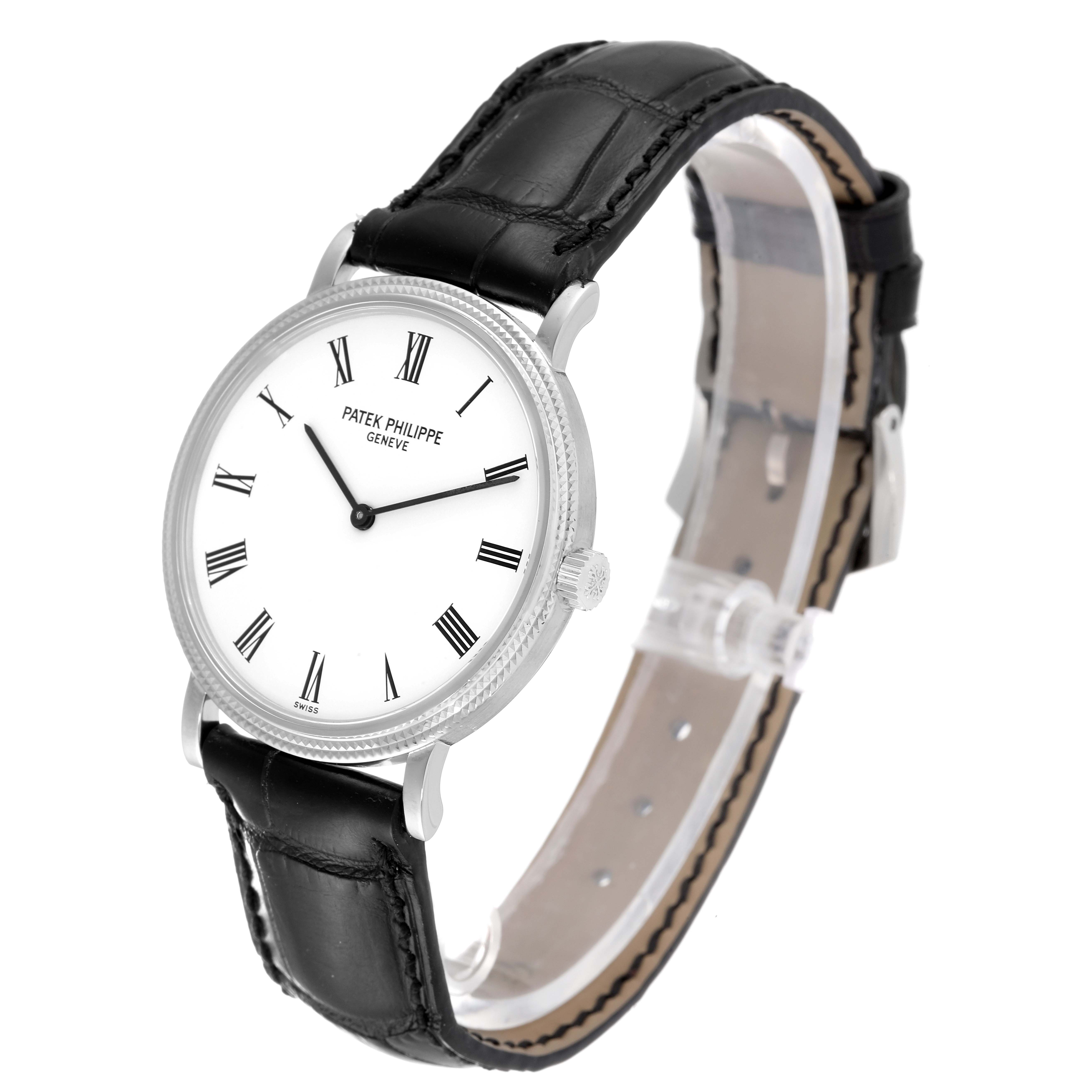 This image shows a Patek Philippe Calatrava 5120G Men's White Gold White Dial 5120G Men's White Gold White Dial watch from a 3/4 angle, featuring its white dial, Roman numerals, and black leather strap.