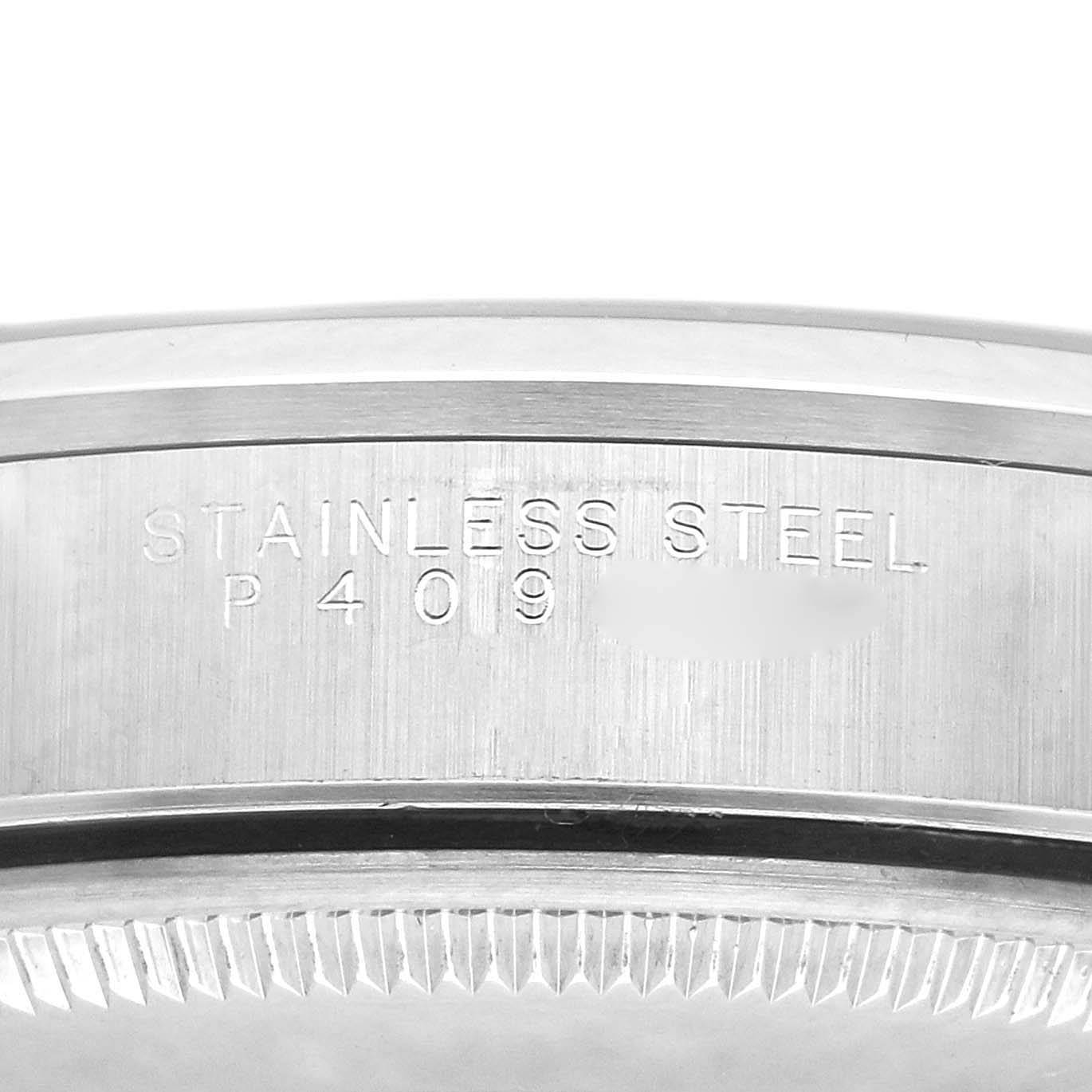 The image shows the side of the case back for a Rolex Air-King model 14000, highlighting the "STAINLESS STEEL" engraving.