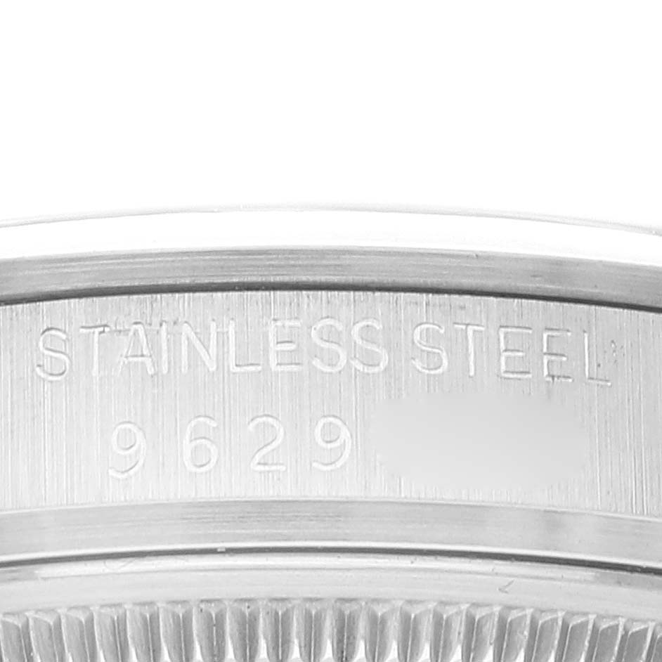 This close-up image shows the case back engraving of a Rolex Date 15000 Men's Stainless Steel Silver Dial 15000 Men's Stainless Steel Silver Dial model watch, indicating "STAINLESS STEEL" with a numeric code.