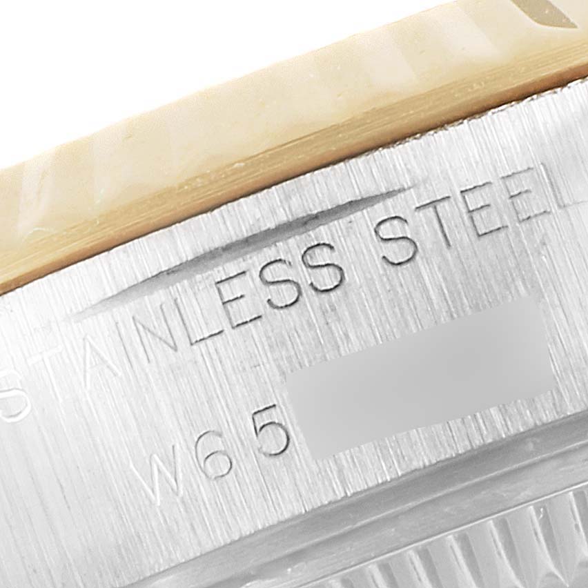 The image shows a close-up of the engraved side of a stainless steel Rolex Datejust 69173 Women's Steel and Gold (two tone) Champagne Dial 69173 Women's Steel and Gold (two tone) Champagne Dial watch case.