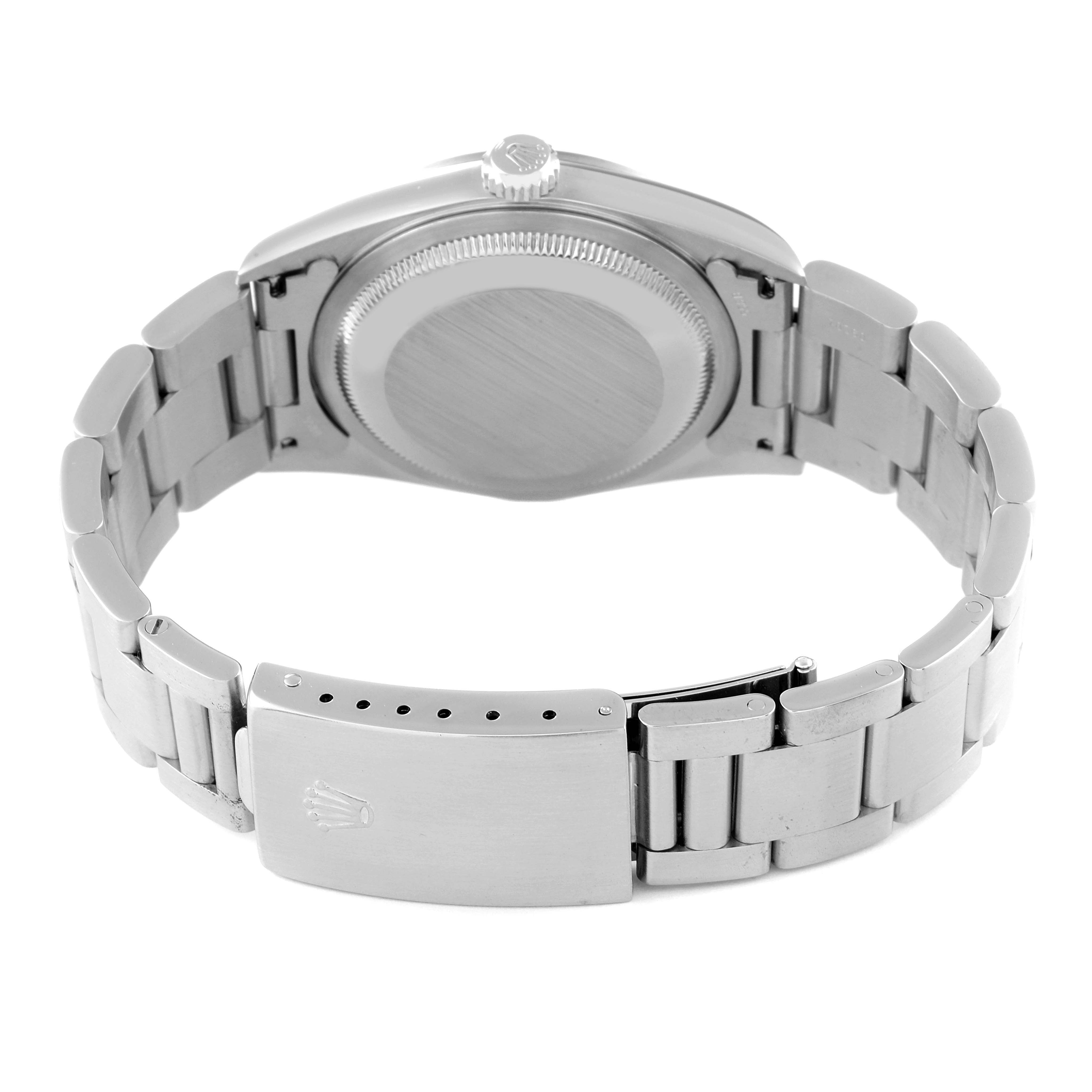 The image shows the back side of the Rolex Datejust 16200 Men
s Stainless Steel Pink Dial 16200 Men
s Stainless Steel Pink Dial watch along with its bracelet and clasp.