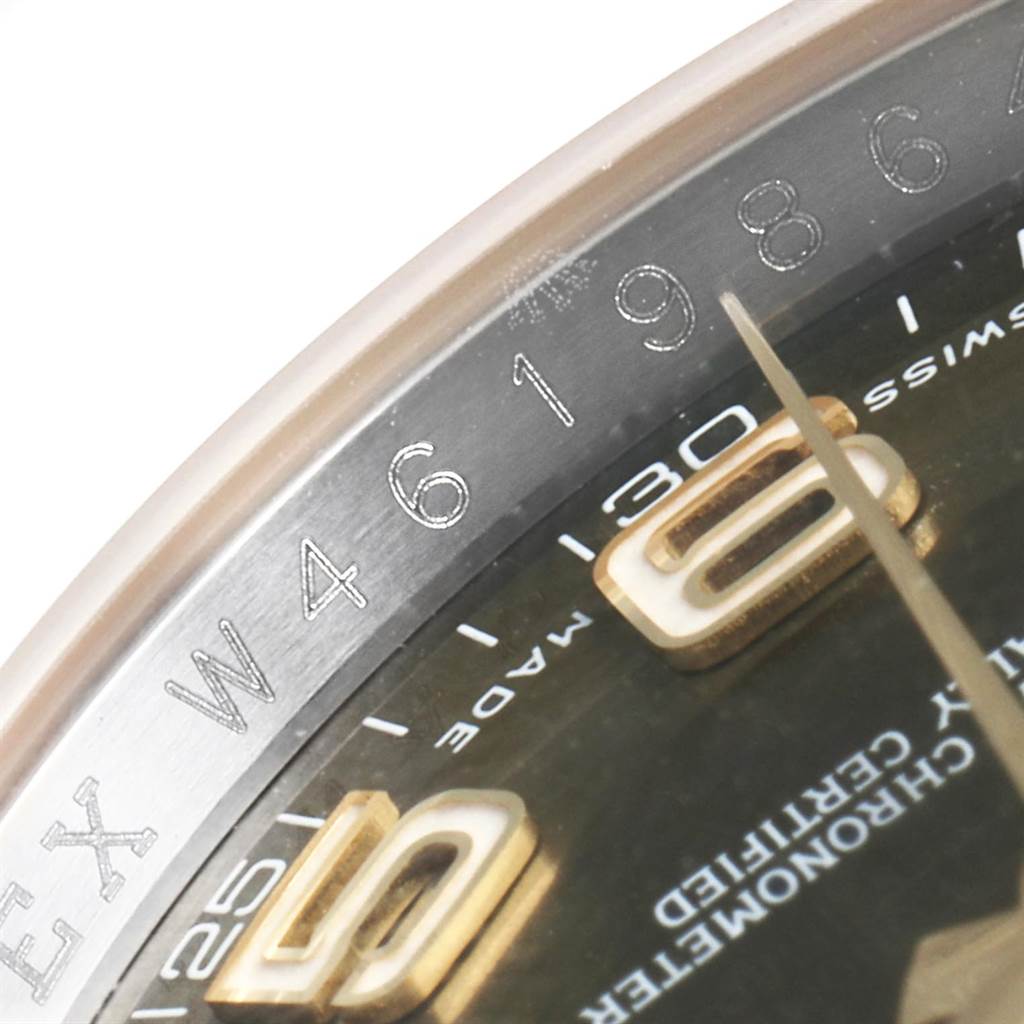 The image shows a close-up of the Rolex Datejust 116203 Men's Steel and Gold (two tone) Brown Dial 116203 Men's Steel and Gold (two tone) Brown Dial watch's dial and partial bezel, highlighting the serial number and hour markers.