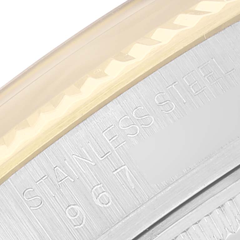 The image shows a close-up of the edge of a Rolex Vintage Collection 16013 Men's Steel and Gold (two tone) Champagne Dial 16013 Men's Steel and Gold (two tone) Champagne Dial watch, focusing on the stainless steel bezel and engraving.
