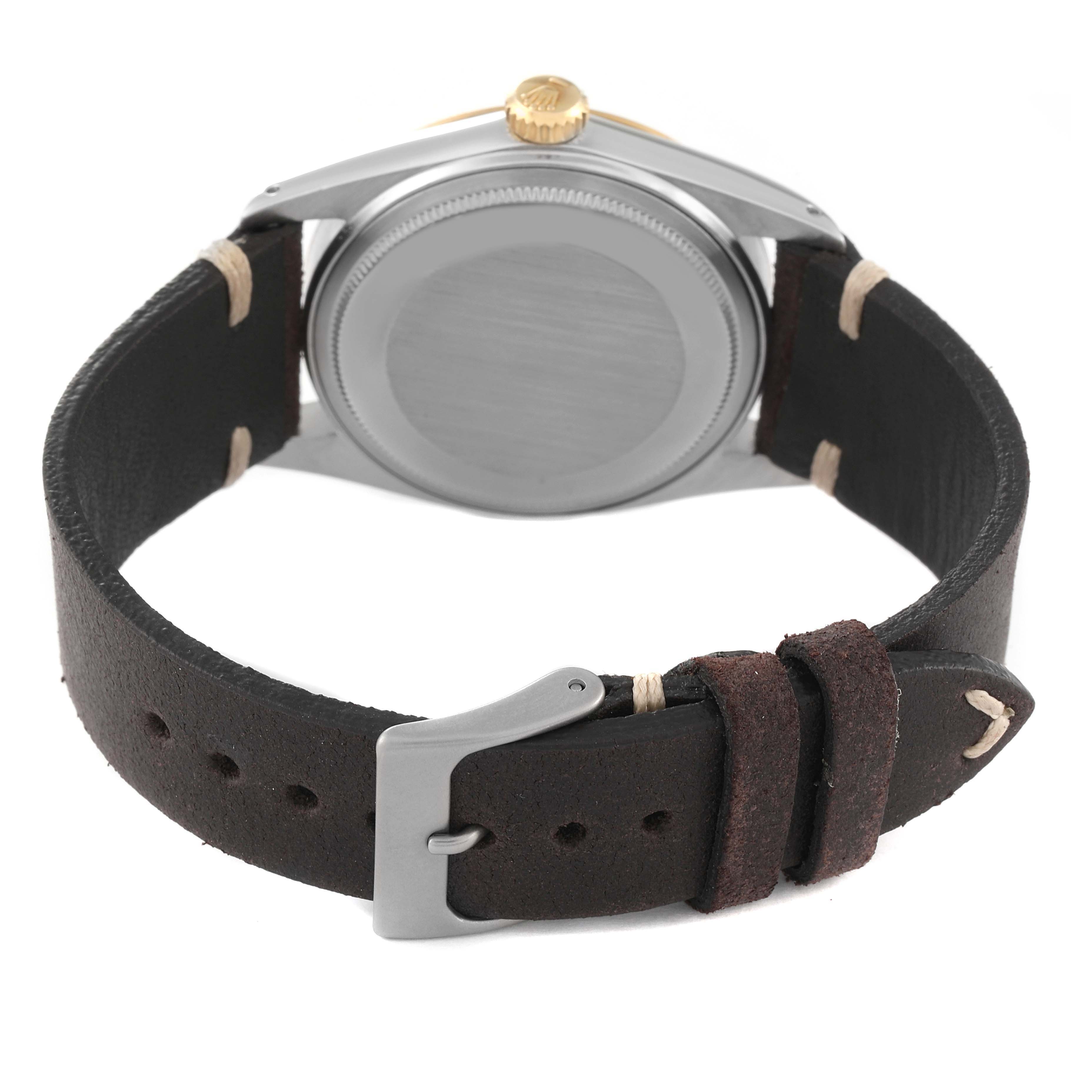 This image shows the back view of a Vintage Collection Rolex watch, highlighting the caseback and leather strap with a buckle.