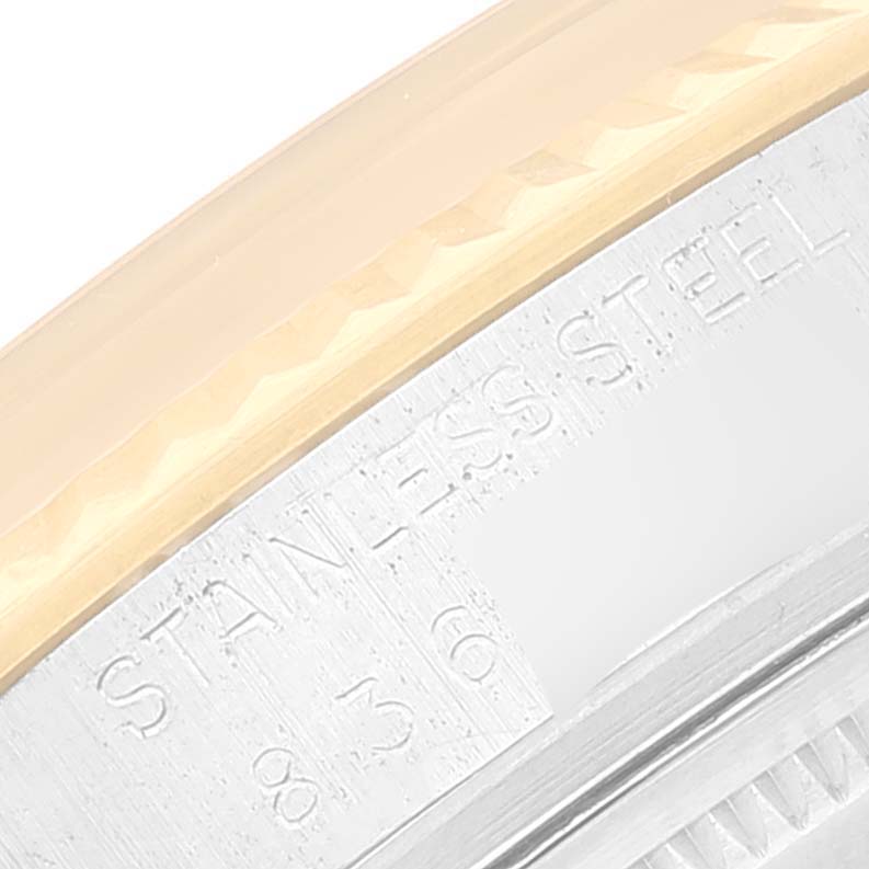 This image shows a close-up of the bezel and case edge of the Vintage Collection model by Rolex, highlighting the "STAINLESS STEEL" engraving.