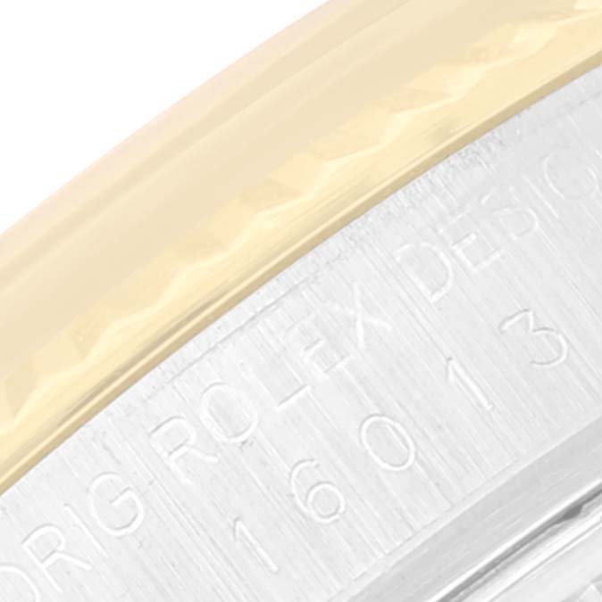 This close-up image of the Rolex Vintage Collection 16013 Men's Steel and Gold (two tone) Champagne Dial 16013 Men's Steel and Gold (two tone) Champagne Dial watch shows part of the bezel and engraved serial number on the case side.