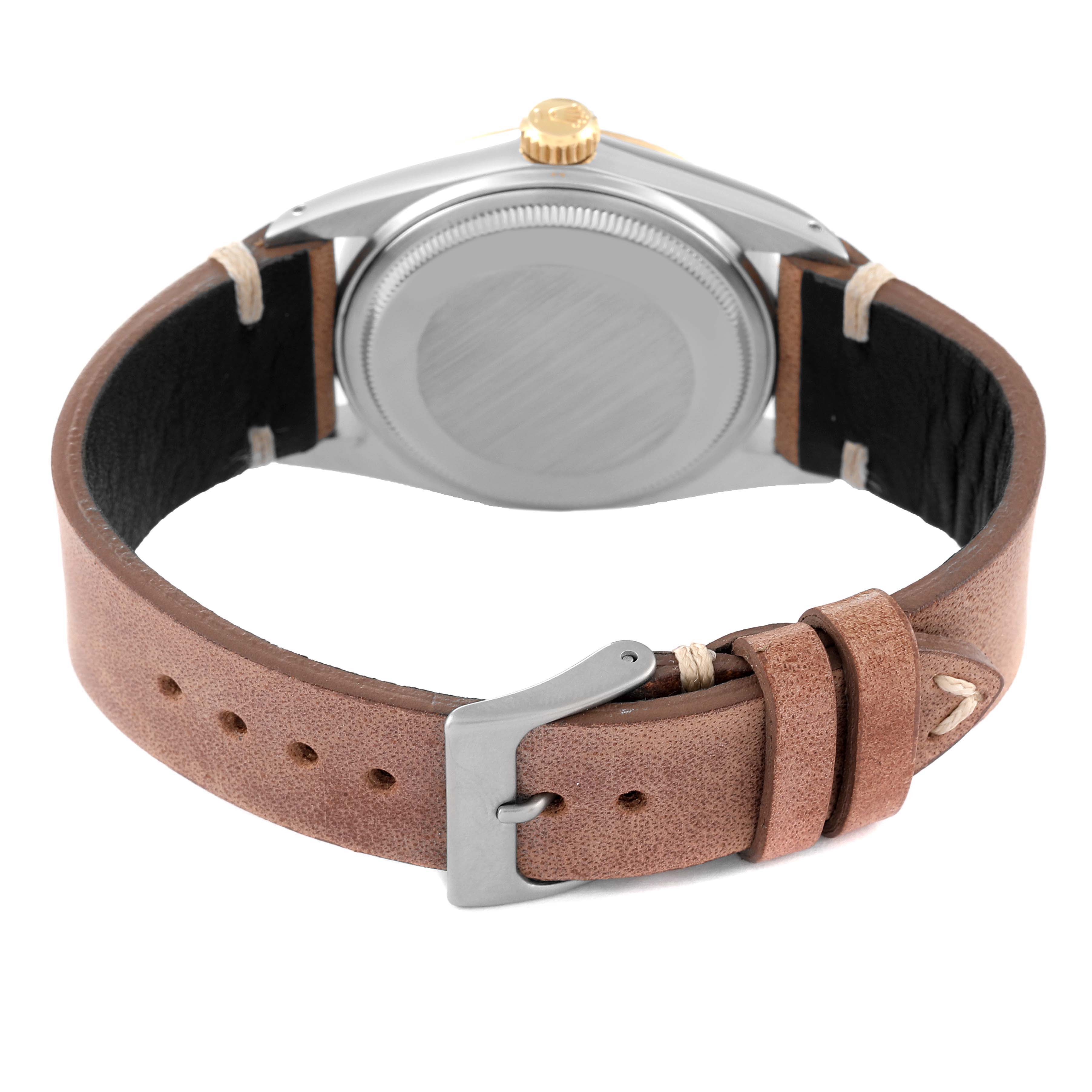 The image shows the back of the Rolex Vintage Collection 16013 Men's Steel and Gold (two tone) Champagne Dial 16013 Men's Steel and Gold (two tone) Champagne Dial model, featuring its case and brown leather strap with a buckle.