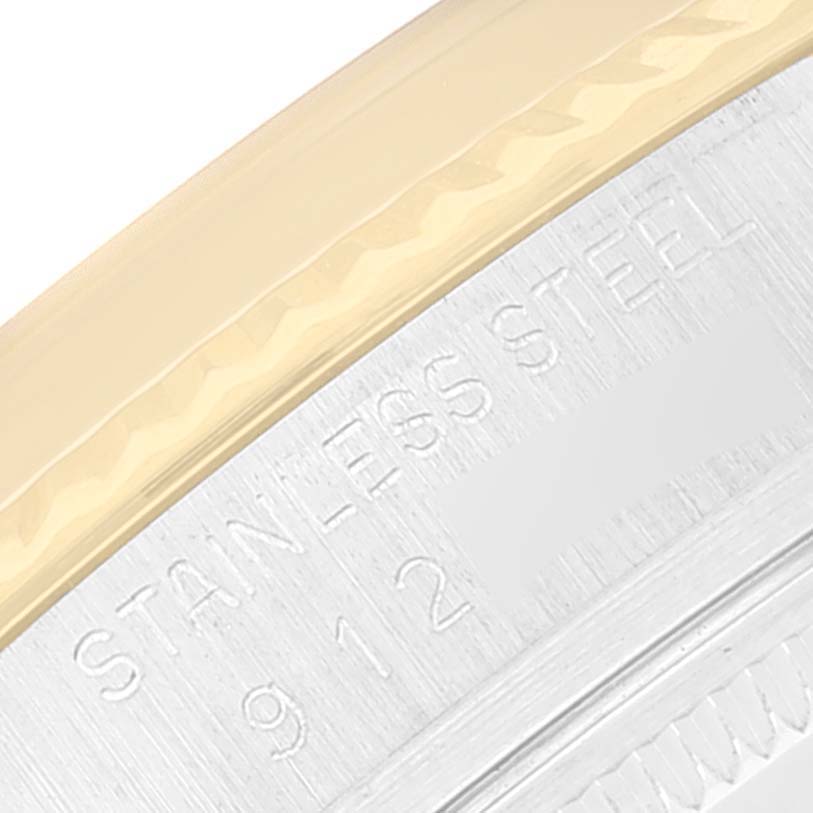 The image shows a close-up of the edge and part of the casing, revealing "STAINLESS STEEL" text, of a Rolex Vintage Collection 16013 Men's Steel and Gold (two tone) Champagne Dial 16013 Men's Steel and Gold (two tone) Champagne Dial model.