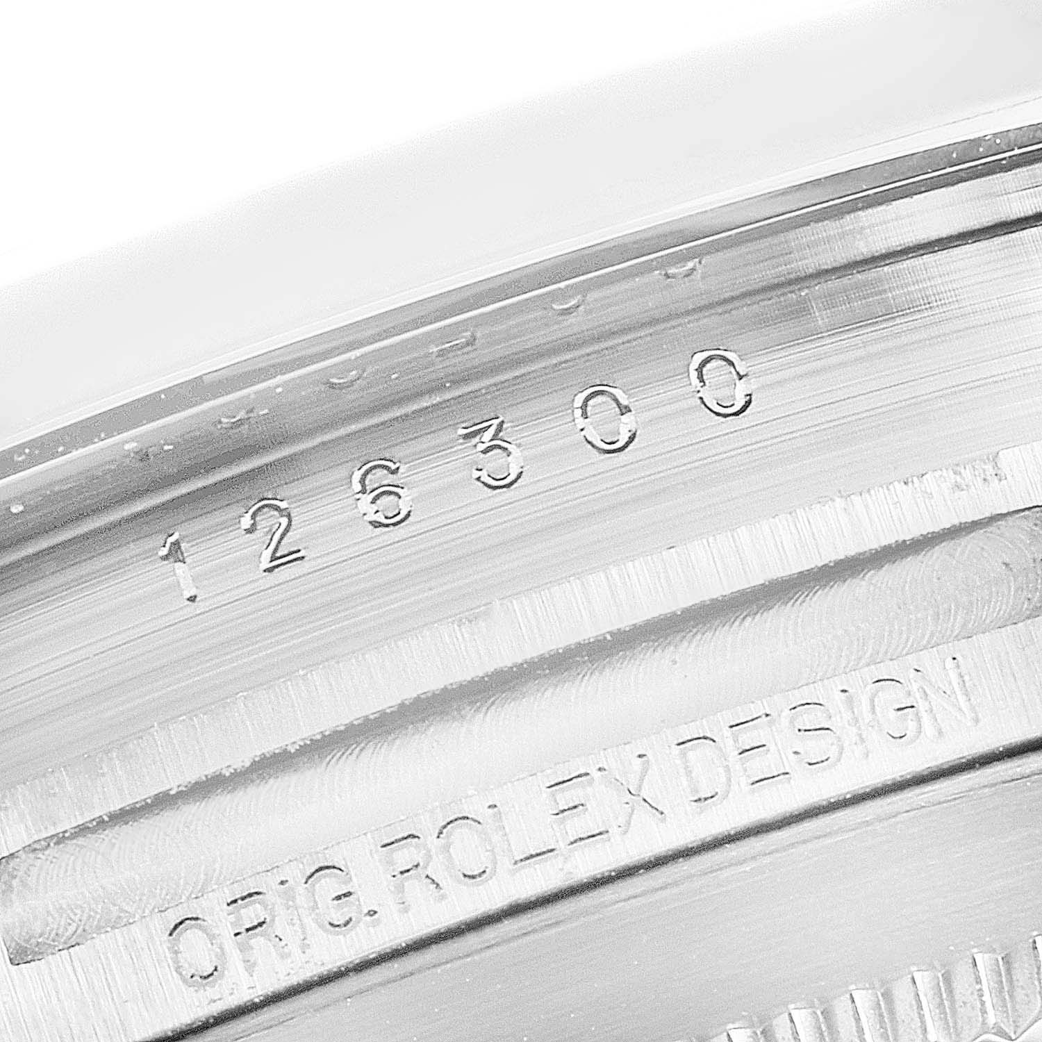 This image shows a close-up of the model number and "ORIG. ROLEX DESIGN" engraving on the side of the Rolex Datejust 41 126300 Men's Stainless Steel Grey Dial 126300 Men's Stainless Steel Grey Dial watch case.