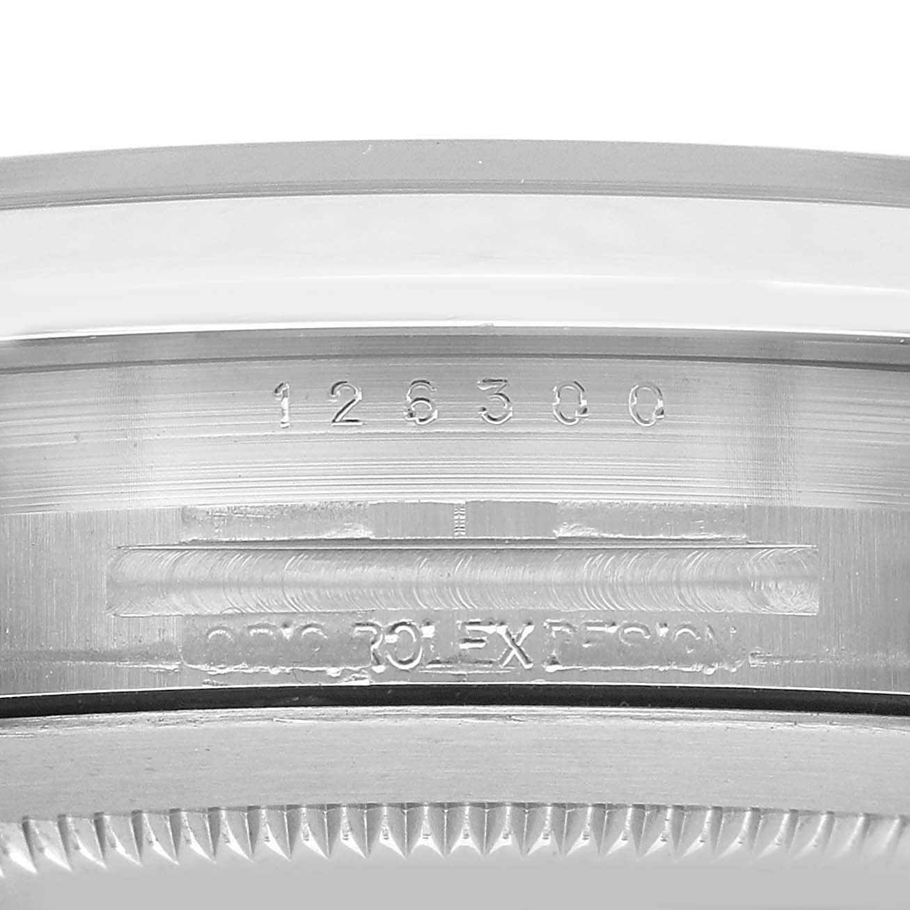 The image shows the case edge of a Rolex Datejust 41 126300 Men's Stainless Steel Silver Dial, highlighting engravings and the fluted bezel.