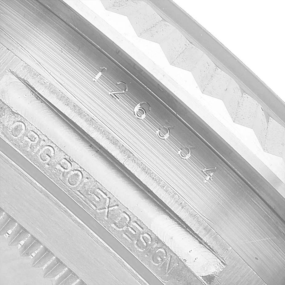 The image shows the side of the Rolex Datejust 41 126334 Men's Stainless Steel Grey Dial, focusing on the engraved serial number and "Rolex Design" markings.