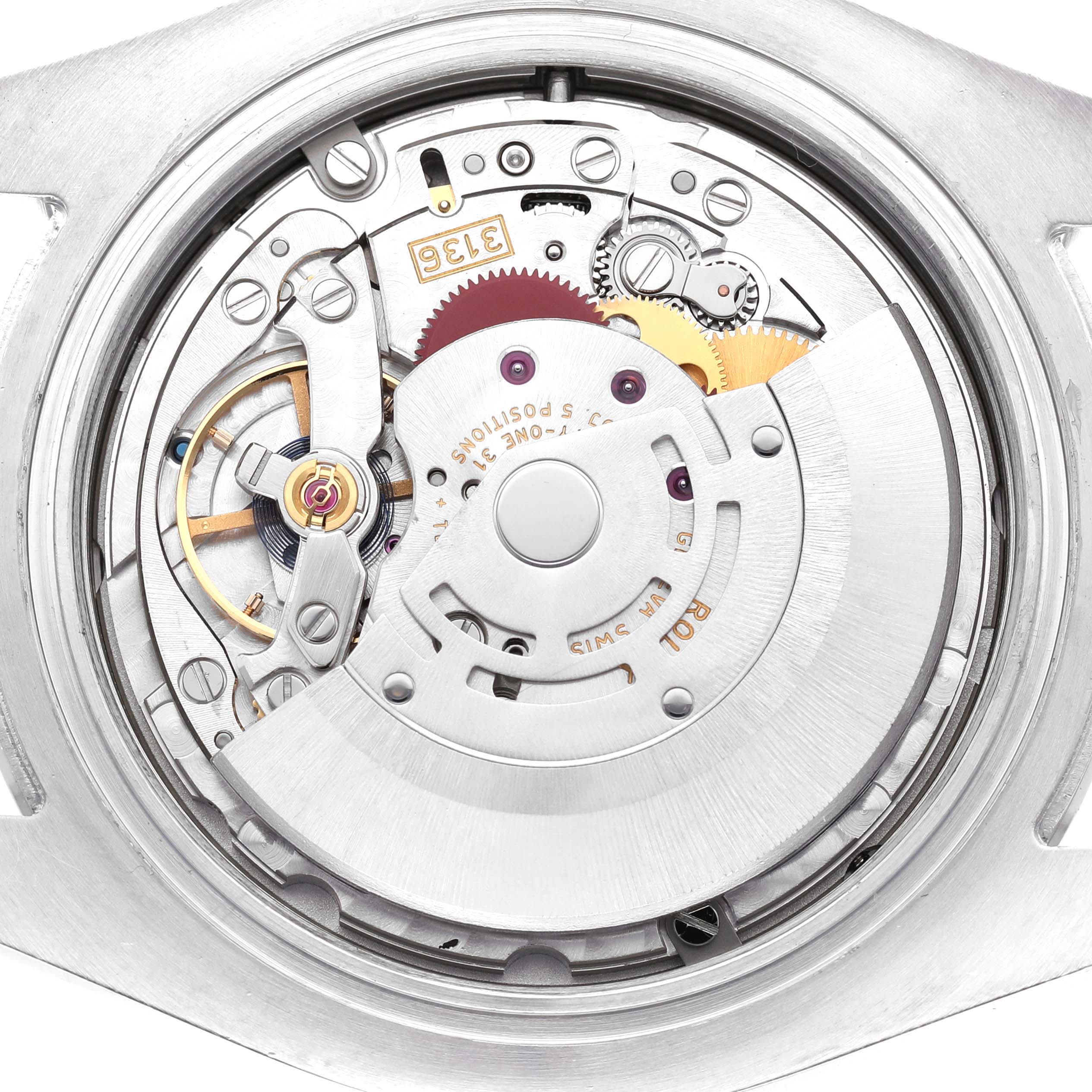 The image shows the movement mechanism of a Rolex Datejust 41 116300 Men's Stainless Steel Blue Dial, viewed from the back, highlighting gears and components.