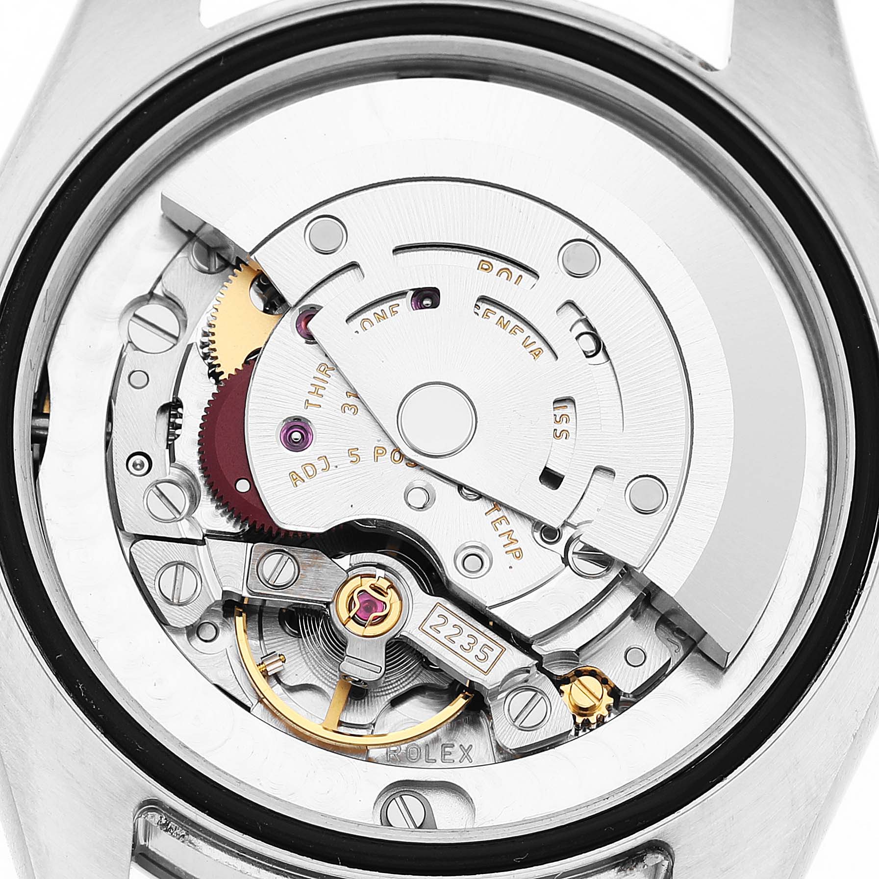 The image shows the movement of a Rolex Mid-Size 178274 Women's Stainless Steel Blue Dial watch from a rear angle, highlighting its intricate mechanical parts.