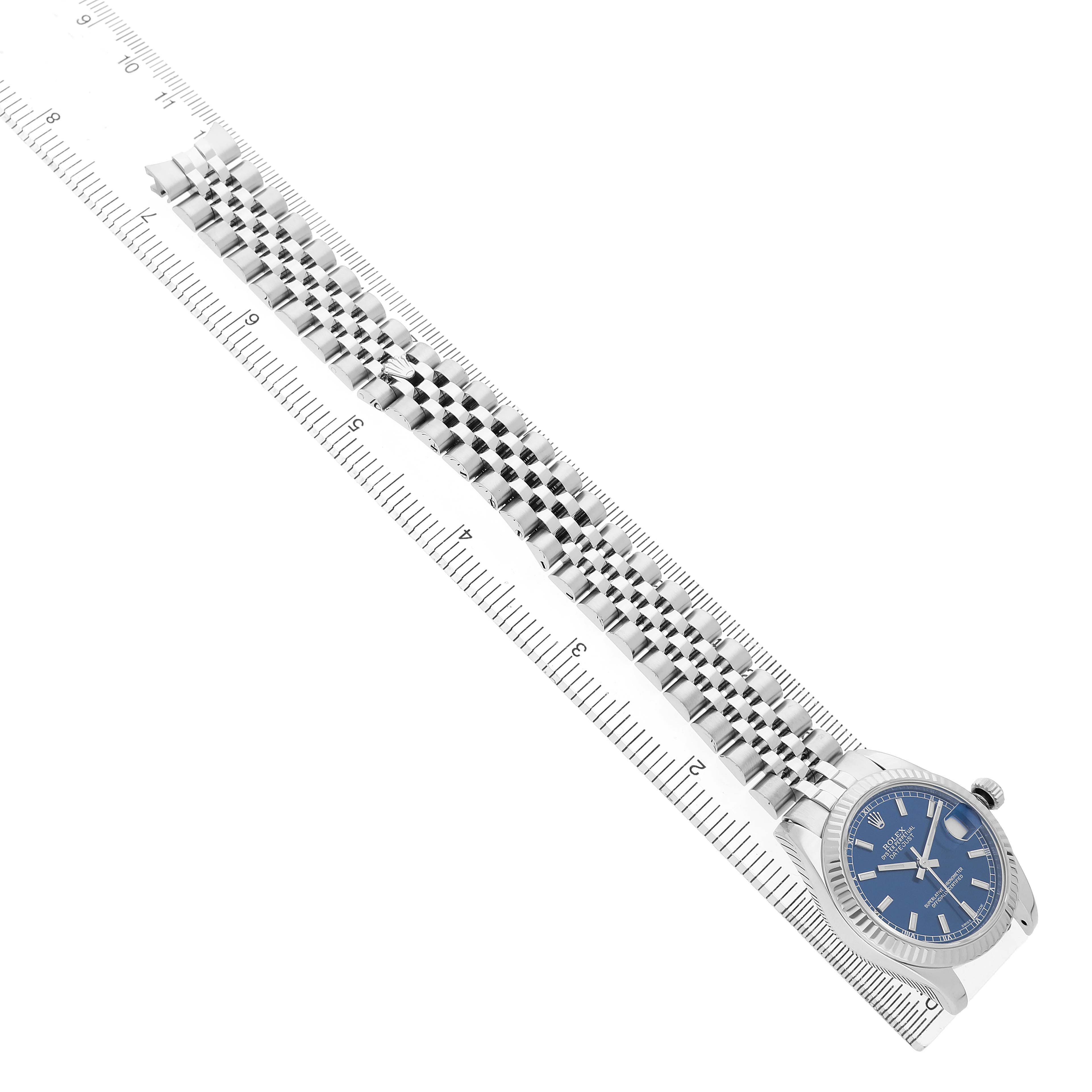 The Rolex Mid-Size 178274 Women's Stainless Steel Blue Dial watch is shown from an angled side view, featuring the face, bezel, and bracelet alongside a ruler for scale.