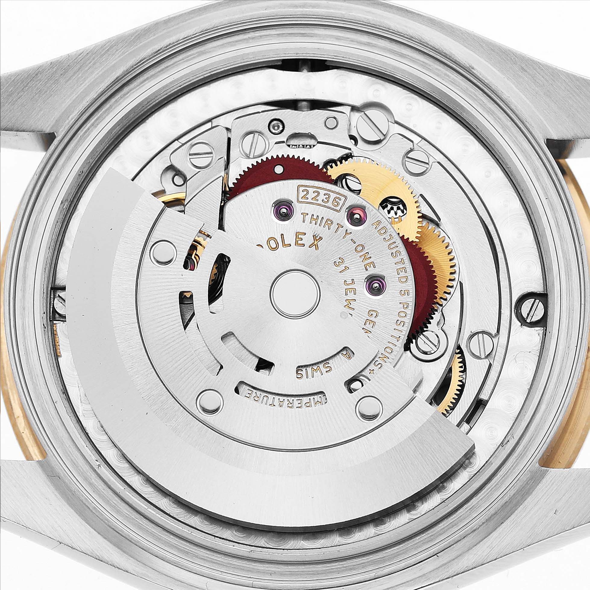 The image shows the internal mechanism of a Rolex Mid-Size 82598 Women's Steel and Gold (two tone) Mother of Pearl Dial watch with visible gears and the rotor.