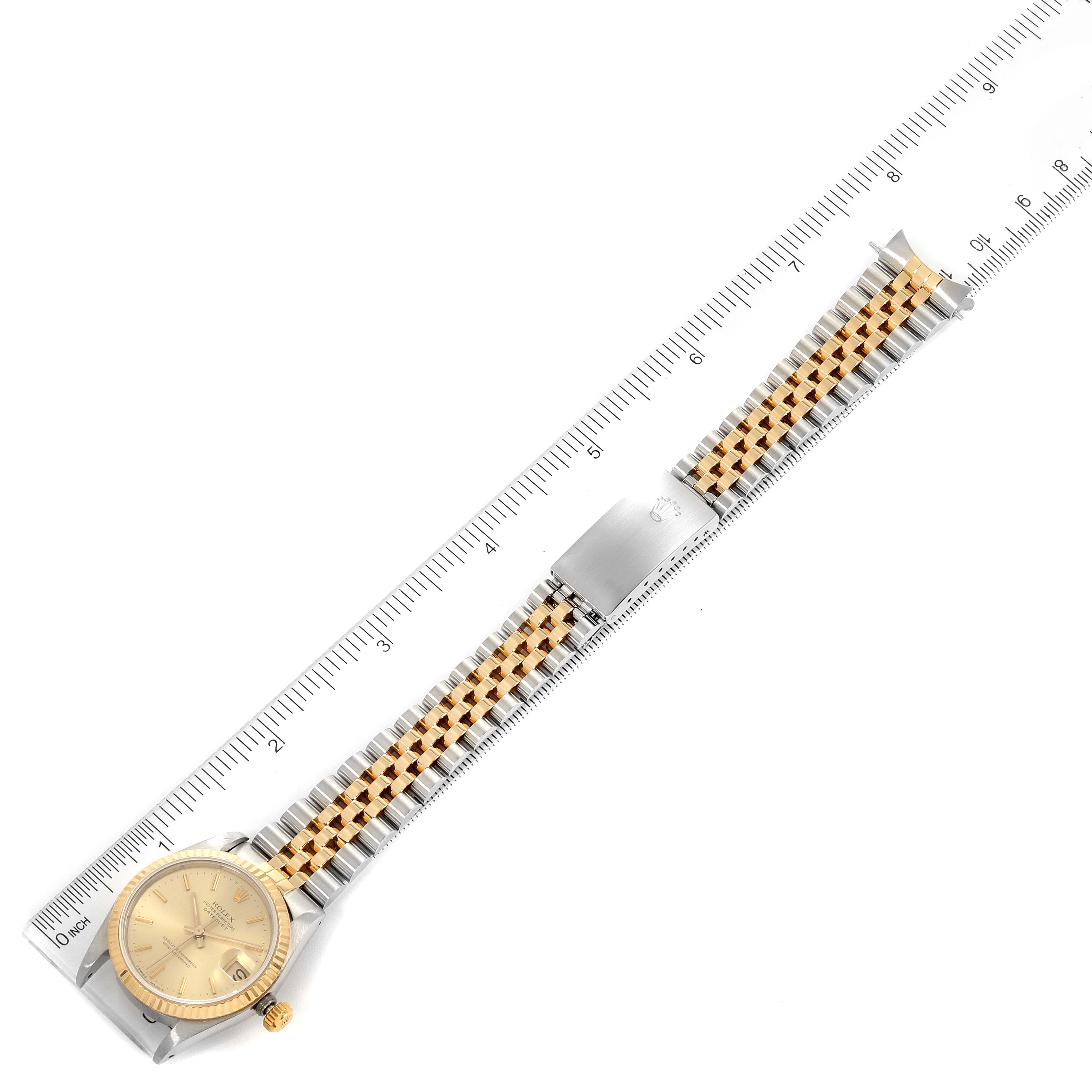 The Rolex Mid-Size 68273 Women's Steel and Gold (two tone) Champagne Dial 68273 Women's Steel and Gold (two tone) Champagne Dial watch is displayed flat with a ruler measuring its length, showing the face, bezel, crown, and bracelet.