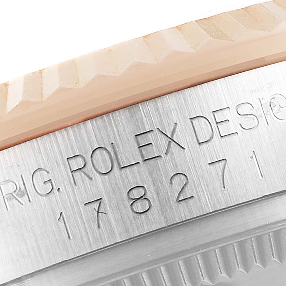 Close-up of the side of a Rolex Mid-Size 178271 Women's Steel and Gold (two tone) Pink Dial 178271 Women's Steel and Gold (two tone) Pink Dial model, showing the engraved serial number and part of the bezel.