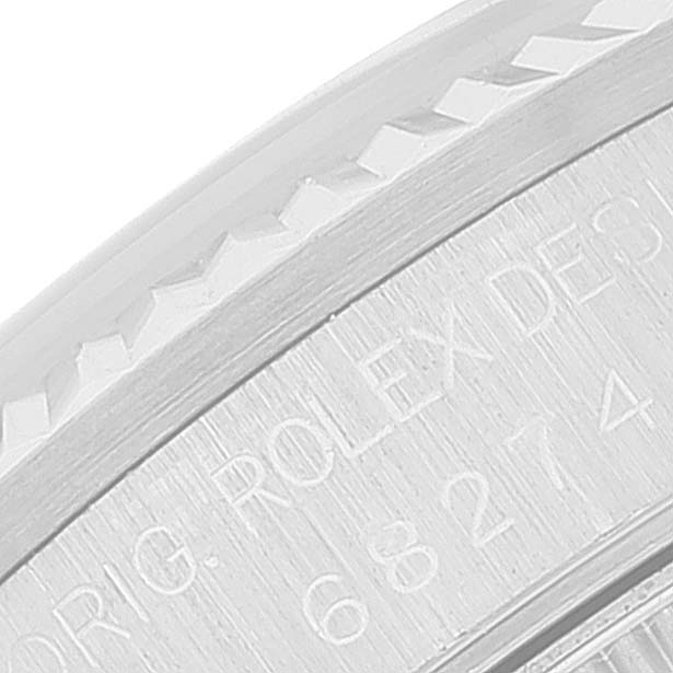 This close-up image shows part of the engraved case back and the edge of the bezel of a Rolex Mid-Size 68274 Women
s Stainless Steel Pink Dial 68274 Women
s Stainless Steel Pink Dial model watch.