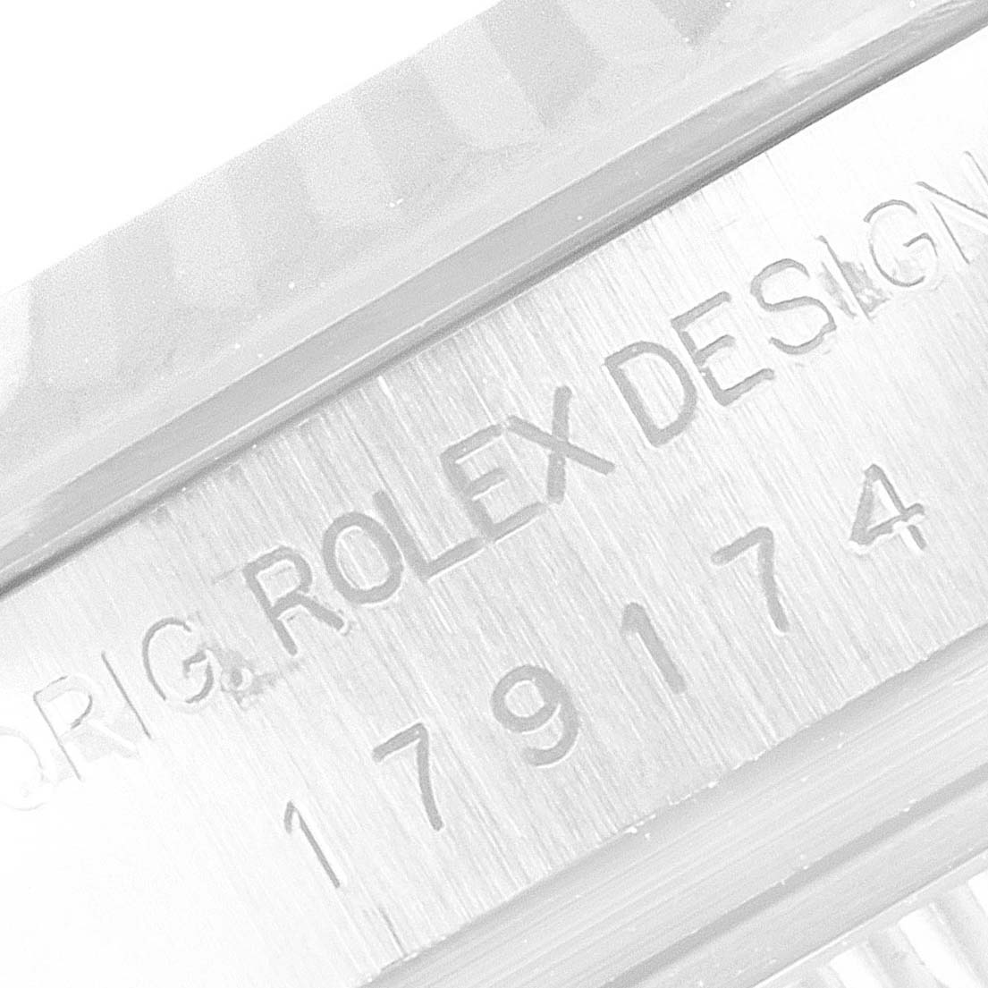 The image shows a close-up of the serial number and engraving on the case of a Rolex Datejust 179174 Women's Stainless Steel Black Dial 179174 Women's Stainless Steel Black Dial watch.