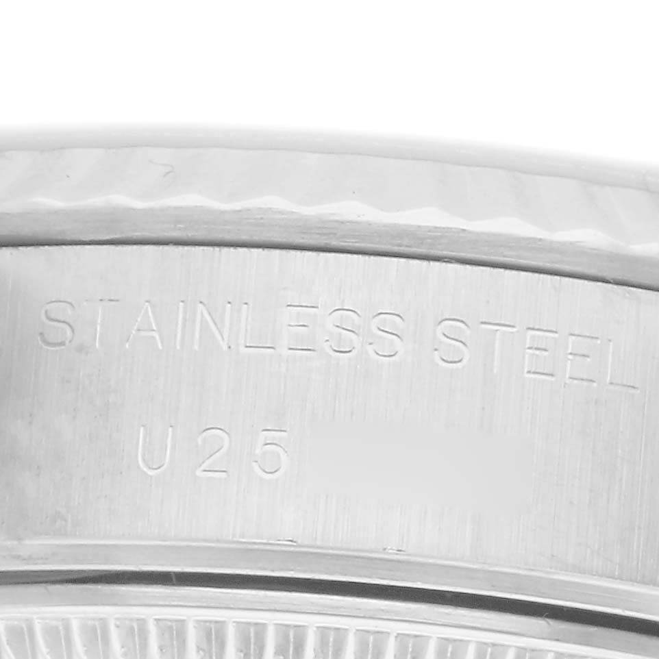 The image shows a close-up of the engraved case back edge, highlighting the "STAINLESS STEEL" marking on the Rolex Datejust model 69174 men's watch.